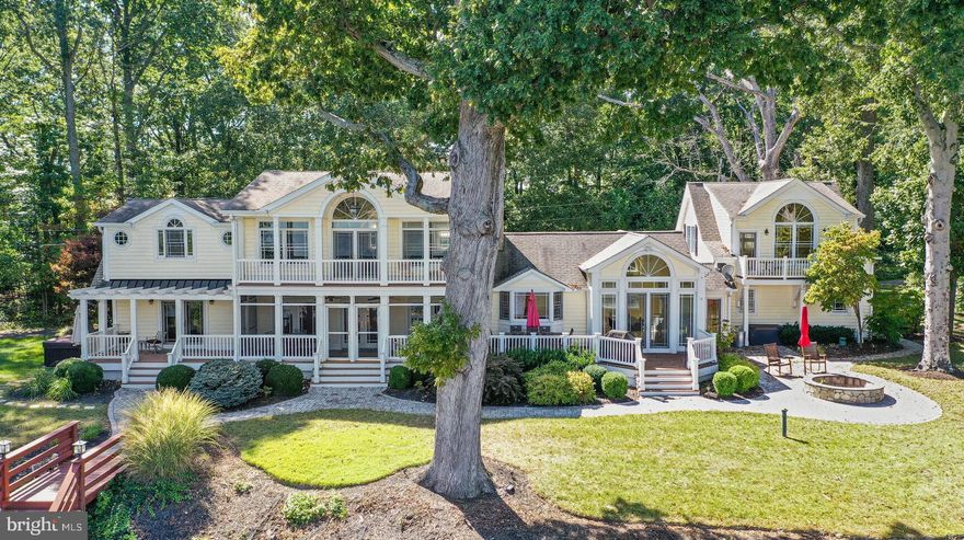 THIS IS THE OASIS OF A LIFETIME.  Live, laugh and love in your own full-service resort with 
500 feet of soothing waterfront and water views from nearly EVERY WINDOW! Recipe for having a wonderful life on a daily basis: enjoy the gorgeous private pier,  rev up your boat and utilize one of the two large boat lifts OR Jet Ski (also two lifts!) your way to waterfront dining and fraternizing.  If you want to hang out at home, eat crabs on the dock with built-in picnic bench, or if you prefer dining on land at your Chesapeake retreat, sit outside in a multitude of patios/decks/balconies or sit on the custom stone patio and get the waterfront firepit going to chase the chill away, cook atop the fire or chat amidst the lovely lighting and outdoor sound system.....OR,  grab a lounge chair and contemplate life on the property's private sandy beach! The main house boasts a floor plan that can accommodate many or a few with private bedroom suites, large congregating areas, gourmet kitchen complete with heated flooring, two beverage refrigerators and commercial-grade ice maker. Thoughtful comfort additions include a waterfront hot tub, whole house generator and surge protector, pellet stove, elevator, extensive outdoor lighting, water softener, 4-zone HVAC, zoned irrigation system, huge shed and professional landscaping.  This stunning compound features a freshly renovated one-bedroom cottage (with sweet loft) where visitors can cook breakfast and enjoy coffee on their own screened porch and sundeck. Marvel over the flora, fauna and majestic skies while ensconced in your own slice of perfection. To make life even easier, this special property conveys with an American Home Shield Home Complete Warranty.