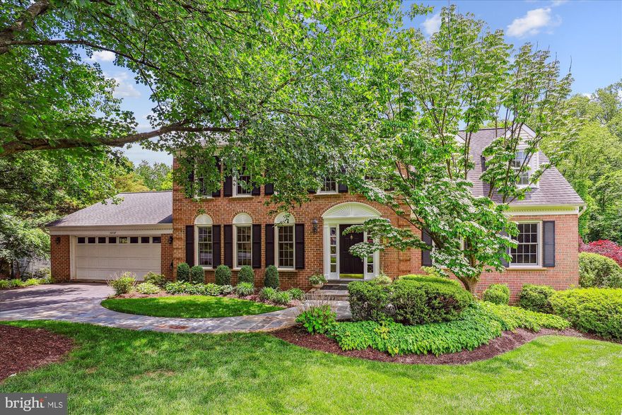 This lovely "tree house" colonial sits comfortably nestled in an idyllic natural oasis in one of Vienna's most sought-after communities.  Though only minutes from Reston Towne Center, Tysons Corner, and downtown Vienna, you are on a quiet cul de sac, in an oasis of green space, literally surrounded by 50+ acres of public forest and parks, with walking trails, streams, and easy access to the W&OD bike path.  Sip your morning coffee on the tranquil screened porch, as you watch the deer and foxes wend their way through your backyard in search of breakfast.  Take your daily walk by going through your backyard to the trails and walk for literally miles, your only companions the wildlife.  And end your evening with a glass of your favorite vintage in the hot tub on the deck, as the crickets serenade you in total privacy.  Updated to absolute perfection, this brick front colonial with handsome blue stone walkway offers almost 5,000 square feet of light filled and practical space on .57 acres.  The sprawling main level is floored in gleaming hardwood.  It features formal living and dining rooms with ample natural light and elegant trim work.  The dining room thoughtfully flows out both to the living room and to the screened porch, ideal for holiday dinners and large-scale entertaining.   The stylish updated kitchen boasts cream cabinetry, granite counters, stainless steel appliances, and a bright breakfast room that flows seamlessly into the family room.  The family room is highlighted by a white-washed brick fireplace and provides access to the rear deck and hot tub.  A practical home office with a wall of built-ins sits off the foyer, overlooking the leafy front yard.  A functional laundry/mudroom and a stylish powder room complete the main level.  Upstairs, the expansive owner's retreat offers a large bedroom, two walk-in closets, and a spa-like ensuite with a separate glass-sheathed shower, free-standing soaking tub, and double vanity with a cabinet tower for ample storage. Three additional generous bedrooms share an updated full bath.  The walkout lower level provides an enormous, full daylight recreation room with built-in shelving, perfect for game night and Sunday football with friends, along with a private fifth bedroom and bath for long-term guests.  The lower level also includes a large unfinished storage room, which would be ideal for a future home gym.  Outside, you have paradise ... an inviting deck with hot tub, a screened porch, and a lower-level patio, all enjoying tranquil views of the surrounding parkland.  Why would you ever leave for vacation?  Water heater replaced 2025, HVAC replaced 2018, Windows, Roof, and Siding replaced 2010.  Madison High School.