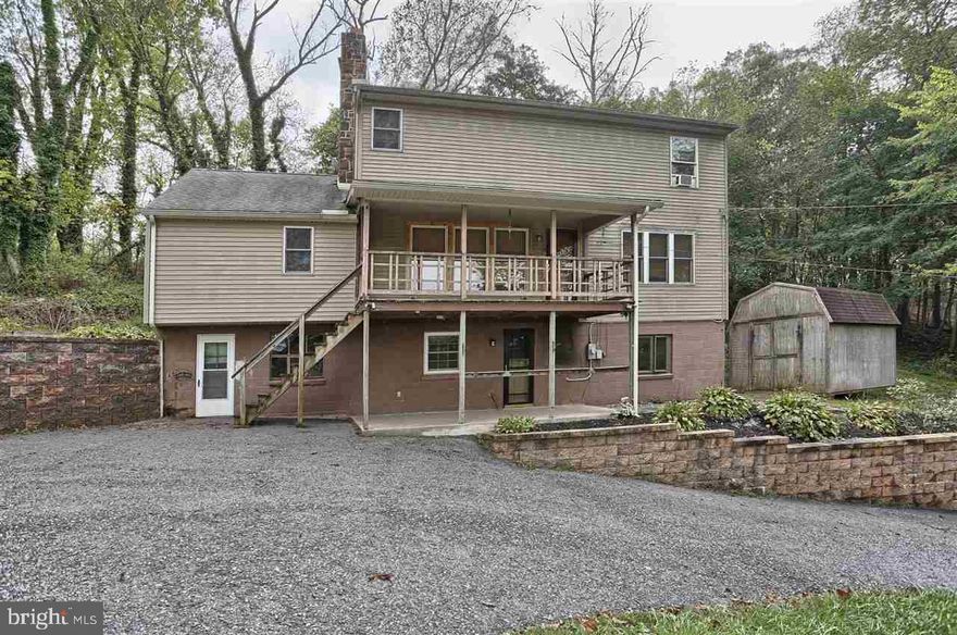 Up in the trees and totally private, on 1.6 Acres, overlooking the Conewago Creek is this 3 BR, 3 Bath 2 Sty home somewhat in the tradition of a log cabin interior with stone fireplace, pine walls and ceilings.  Family Room, Office, workshop, storage area and workshop too.  Large gravel parking area.   A best buy and needing only a little TLC.  Make sure you see the pictures.