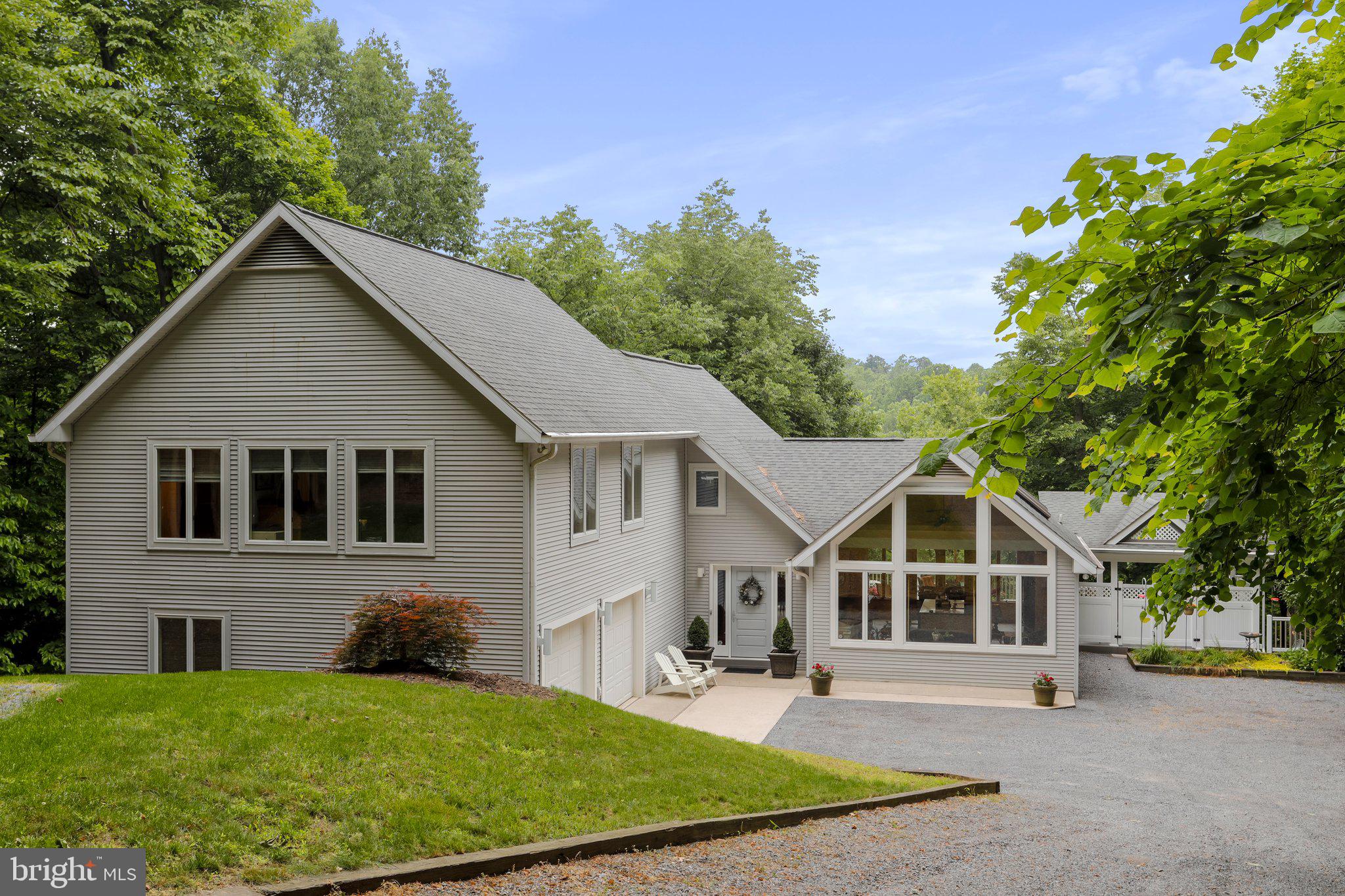 Paradise awaits in your dream home on the river! Nestled in a blanketing seclusion of trees above the river makes you feel like you're living in a tree house! This quality-built home was designed by a local renowned architect and custom built with impeccable taste in finishing materials (such as hand crafted, custom wood cabinetry and stairs), desired amenities, functionality and features that truly let you enjoy the presence of the river. The main level offers a gourmet kitchen boasting granite counters, island with cooktop and breakfast bar, skylights, a spacious dining area and a sitting area adorned by plenty of windows and sunlight. Gather and relax in the family room with wood burning, stone fireplace with heatilator and plenty of windows providing breathtaking views. Also on the main level is a bedroom (currently used as den) and a luxuriously large full bath. Upstairs offers a primary suite with exquisite bath and glass double doors leading to a loft area which walks out to a Juliet balcony ideal for enjoying the river view with your morning coffee or evening wine. Also on the upper level is another bedroom with full bath and a large laundry room. The rear deck is the full length of the house and is accessible through French doors in the living room and another door in the dining area. The flow and openness of the kitchen and living room to the two-level deck provides the perfect layout for entertaining river front style! Stepping down off the deck you'll find a brick patio perfect for grilling and providing plenty of space for gathering. The beautiful back yard leading to the river is an oasis for recreation or relaxation, especially if you're lounging in the hammock on the additional separate deck catching the river breeze and watching the canoes and kayaks glide by. Need storage? No problem! The partial basement area is accessible from the outside. Its walk-out level and provides great space for all the tools, work shop or hobby area. The crawl space is accessible from there. There's also a full attic with pull-down stairs. Updates and "extras" include two hot water heaters (one for each level) 400 amp electric service with two 200 amp panels, dual zoned heating/air, water softener, UV light, alarm system and more! Schedule your tour of this rare beauty before its gone!