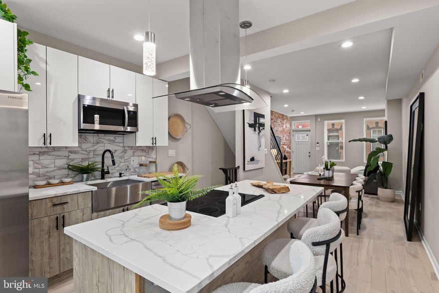 Introducing 1416 N. Dover Street! This remarkable renovation impresses immediately with three bedrooms and three full baths. Enter to hardwood floors, exposed brick wall, and floating stairs between a spacious living and dining area and open kitchen. Upgraded appliances and range hood highlight a kitchen featuring soft-close, white shaker cabinets. Spacious rear patio. Upstairs, amply apportioned primary bedroom suite with upgraded closet and ensuite bathroom with walk-in shower. Secondary bathroom in the hallway and rear bedroom. In the basement, a third bedroom with egress window, full bath with walk-in shower, and laundry. Around the corner from Athletic Square Park, Together Skateboarding & Cafe, and convenient to Center City Philadelphia and Fairmount Park. Visit an open house this weekend or schedule your private showing today!