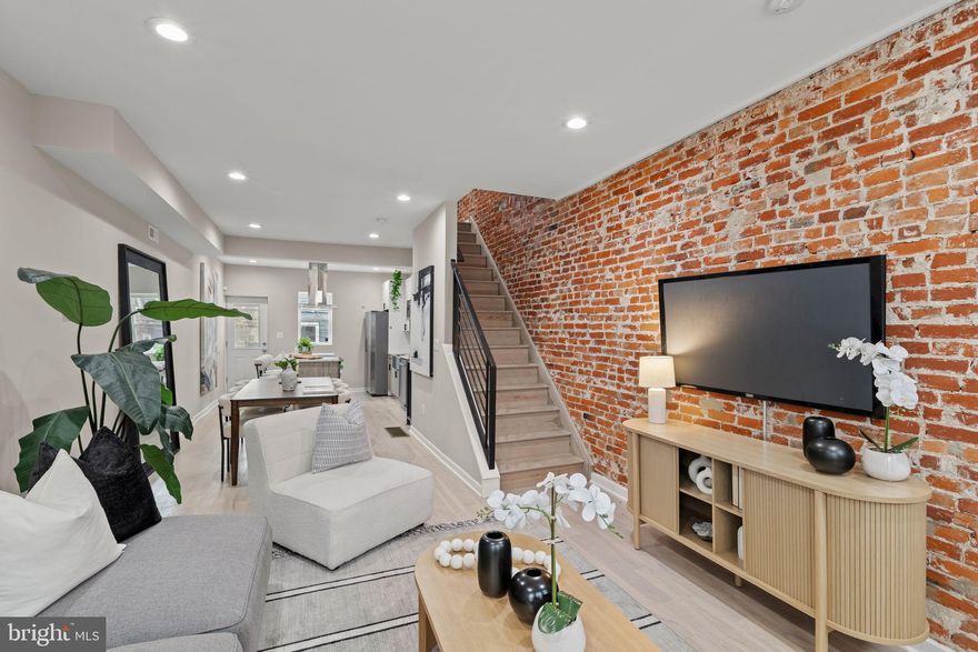 Introducing 1416 N. Dover Street! This remarkable renovation impresses immediately with three bedrooms and three full baths. Enter to hardwood floors, exposed brick wall, and floating stairs between a spacious living and dining area and open kitchen. Upgraded appliances and range hood highlight a kitchen featuring soft-close, white shaker cabinets. Spacious rear patio. Upstairs, amply apportioned primary bedroom suite with upgraded closet and ensuite bathroom with walk-in shower. Secondary bathroom in the hallway and rear bedroom. In the basement, a third bedroom with egress window, full bath with walk-in shower, and laundry. Around the corner from Athletic Square Park, Together Skateboarding & Cafe, and convenient to Center City Philadelphia and Fairmount Park. Visit an open house this weekend or schedule your private showing today!