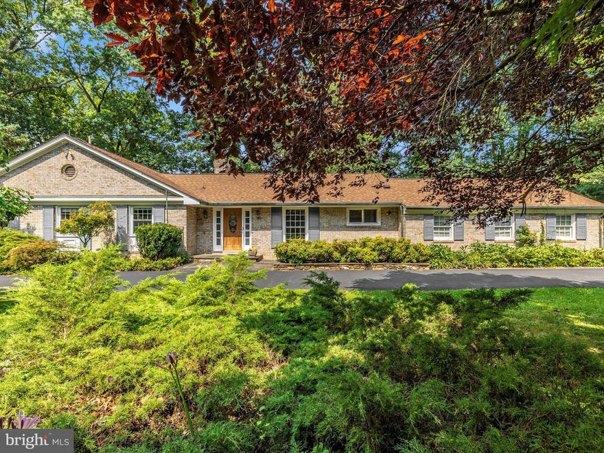 Wonderfully maintained 4 bedroom, 3 bathroom main level living estate that welcomes your arrival via the circular driveway or the side load 2 car enormous garage with overhead storage, workbenches and closet space.  Hardwoods throughout the main level gleam as they have been covered by carpet for many years.   A serene sunroom balances the private rear of the home with its own gas stove for cozy appeal and an overhead dedicated mini split heating and air conditioning system.  A large living room, dining room and family sized eat in kitchen are just off the oversized garage.  3 large bedrooms and 2 full baths with an ensuite laundry complete the large first floor.  Amenities include incredible mature landscaping, decks, peaceful and calming gardens, a gorgeous waterfall, sitting benches, trails through the hardwoods and butterfly bushes.  All major renovations include a 2019 roof,  gutter system, copper gutters and downspouts, new chimney flue liners and squirrel/bird cages, new natural gas hot water heater, newer gas furnace and heat pump comfort systems (2021), mini split system in sunroom,  new 2022 refrigerator, septic completely redesigned and upgraded (2022, also pumped).  The upstairs windows have all been replaced.    Gas logs in the lower level rec room where you will find an additional bedroom and full bath, a walkout entrance/exit in 2 places, a large well organized usable utility room and a 2nd laundry.  The rec room is HUGE with a built in bar and a very large storage room with its own closet.  Once outside, the grounds are entirely and truly captivating.  There are so many relaxing areas and with the lake so close, bird and nature enthusiasts will be in heaven!  This one is so special and will welcome you HOME!