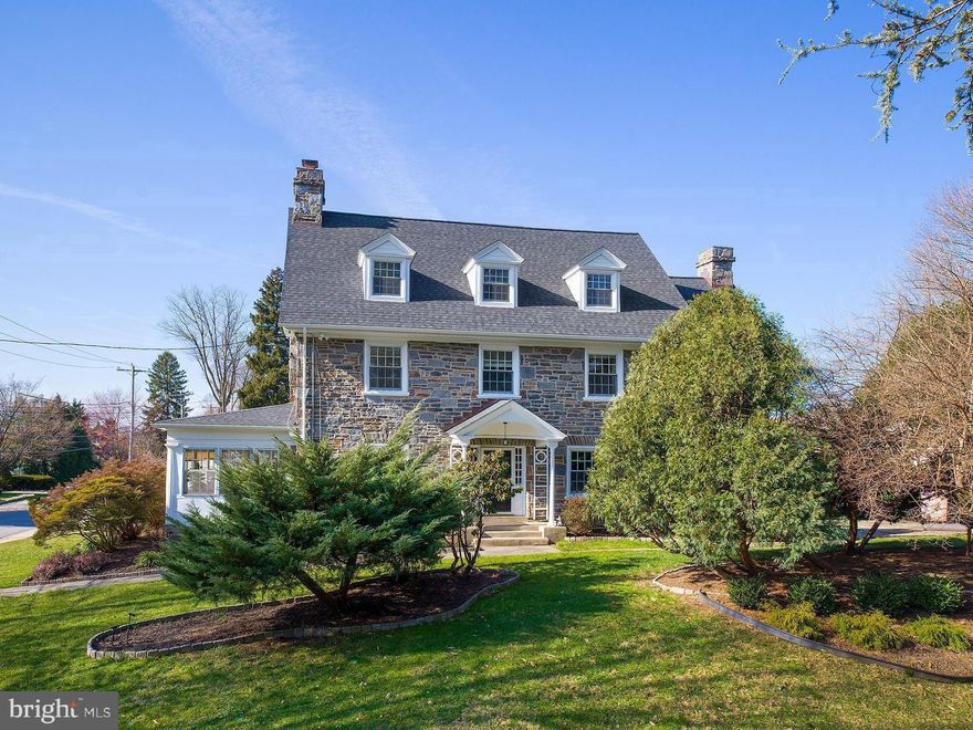 Welcome to 315 N Bowman Ave, Merion Station, where elegance and luxury converge in this exquisite Main Line masterpiece. Celebrating a century of grace, this quintessential center hall stone colonial home invites you to partake in a living legacy, offering a glorious blend of prestige and timeless beauty, nestled in one of the most distinguished neighborhoods.

The exterior of the home is equally captivating, with a long walkway leading from the sidewalk-lined Bowman Ave to a portico covering the step-up front entry, flanked by side lites on either side. The front of the home faces Linden Ln, enhancing its curb appeal and inviting guests with its stately presence.

Yard space extends to the right of the home and to the rear, providing ample outdoor space for recreation and relaxation. Hidden behind lush shrubs is a flagstone patio in the rear of the home, accessible from the mudroom and adjacent to the kitchen, offering a secluded retreat for outdoor dining and entertaining.

Step inside and experience the warmth and charm of this historic residence, where every detail reflects a bygone era of craftsmanship and elegance. As you enter the living room, you're greeted by the warmth of a gas fireplace featuring a stone surround, a majestic haven for relaxation. Glass double doors on either side of the fireplace lead to the enclosed sun porch, offering a tranquil space bathed in natural light. Exposed stone and windows on three sides create a serene ambiance, while classic "shutter" wooden doors add a touch of timeless elegance.

Continuing through the first-floor hallway, you'll find a door to the renovated kitchen, as functional as it is beautiful, boasting stunning stainless steel appliances, white shaker cabinetry with dark hardware, and white countertops. Adjacent to the kitchen is a mudroom/breakfast area, providing access to the flagstone terrace hidden behind shrubs, offering a secluded retreat for al fresco dining. The first-floor powder room adds convenience to this level.

Ascend to the second floor, where you'll discover the luxurious primary suite, divided into two sections, providing a serene escape. Its two walk-in closets offer ample storage, while the adjoining primary bathroom was renovated to exude modern luxury with its glass-enclosed shower, new vanity, and tile flooring. Two additional bedrooms on this floor offer their own unique charm. One bedroom features two built-in bookcases and a built-in desk between, while the other exudes warmth with a wood-burning fireplace and brick surround.

Venture to the third floor, where additional living space awaits. Four bedrooms offer versatility and comfort, with one currently used as an office and another as a music/hi-fi room. A renovated hall bathroom completes this floor, ensuring modern comfort for the entire household.

The fully finished lower level, transformed into a media room, provides endless entertainment possibilities. New carpet throughout and freshly painted walls create a welcoming atmosphere. The lower level powder room offers additional convenience. Two unfinished portions provide ample storage space, ensuring organization and functionality for daily living.

With its seamless blend of historic charm and modern amenities, this residence is ready to offer the ultimate Main Line lifestyle for the next generation, ready to be enjoyed by its next fortunate owner. Enjoy a convenient walk to shops, restaurants, houses of worship, effortless commutes via the nearby Merion train station and bus stop, and close proximity to the award-winning Merion Elementary School.