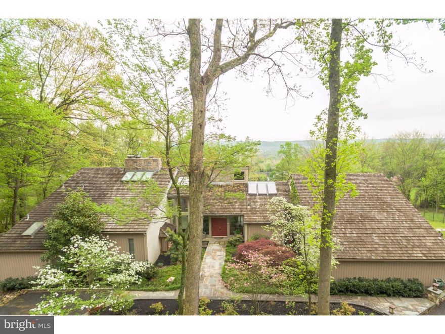 DON'T MISS THE VIDEO of this one of a kind contemporary on a breathtaking 2.7 acre lot w/beautiful gardens, 3 tiered deck, 6 car garage (3 attached 3 detached) + inground pool.  Enter into spacious foyer w/Brazilian cherry floors T/O most of the first floor, floor to ceiling stone wall, closet & powder room.  Behind the stone wall is a magnificent great room w/floor to ceiling stone fireplace & vaulted beamed ceiling, wet bar w/glass cabinetry, granite countertops, refrigerator, wine cooler, ice maker, dishwasher etc.   Dining room has vaulted ceiling & French doors leading to the deck.  State of the Art gourmet kitchen w/large island w/sink, 6 burner gas Wolf stovetop, built-in refrigerator, freezer, ice maker, wall oven & built in coffee pot.  Large breakfast room w/French doors to wraparound deck w/propane gas grill.  Mudroom w/loads of closet space & outside exit to deck.  Also, on this level is the Master Suite w/stone fireplace, MBA, 2 vanities & sinks, tiled shower w/rain showerhead, towel cabinet, heated towel rack, toilet, bidet,  walk-in closet w/built-in cabinetry, washer, dryer, room w/hot tub & sauna leading to an outside deck.  There is also a den w/a stone fireplace on this level.  Walking up a few steps from the kitchen is a bedroom w/ beautiful hardwood floors, a full tiled BA w/skylight, closet, storage & cedar closet.  Walk down a few steps from the kitchen to the 3 car attached garage.  Above the master suite, walk up to a room that is fabulous for inlaw quarters as it has an elevator that goes from this level to the lower levels.  Could be aupaire or office, room presently used as a conference room.  There is a full tiled BA w/skylight.  The lower level has a large great room w/floor to ceiling stone fireplace, sliders overlooking deck with fireplace on the deck & steps down to the beautifully tiled inground pool & gorgeous yard & gardens.  Next to this is another room that is presently used as a billiards room + a wall of bookshelves. 3 good sized bedrooms + 2 full tiled baths & laundry room are on this floor + outside exit.  Storage room w/Central Center for security system, sound system etc. plus climate controlled wine cellar & heating units. Next to the storage room is another room that is being used as an office w/outside exit.  The security system has 4 screens making the exterior doors visible from 4 different areas.  There are 4 HVAC units, generator & built in speakers T/O. Tax appeal has been filed by the Estate.