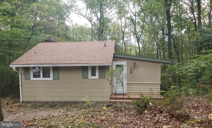 *****GREAT OPPORTUNITY TO OWN A WEEKEND GET AWAY CABIN - OR FULL TIME HOME  IN HISTORIC SHAWNEELAND.   ITS WITHIN WALKING DISTANCE OF THE LAKE, JUST TWO STREETS UP THE MOUNTAIN.   CABIN  SITS ON A BEAUTIFUL WOODED LOT WITH TONS OF PRIVACY.  THERE  IS A BIG DECK ON THE BACK OF THE CABIN OVER LOOKS THE WOODS AND MOUNTAIN SIDE.   KITCHEN HAS A FULL SIZE STOVE, FRIG AND OVER THE COUNTER MICROWAVE.  THE FAMILY ROOM HAS AN AMAZYING STONE WOOD BURNING FIREPLACE, JUST WAITING ON THE NEW OWNER AND THOSE WINTER NITES BESIDE THE FIREPLACE.  WOOD FLOORS ARE UNDER THE CARPET IN THE FAMILY ROOM AND THE BEDROOM. THE POSSIBILITIES ARE ENDLESS. THE CABIN HAS HAD THE ROOF REPLACED WITH ARCHITECTURAL SHINGLES, GUTTERS, AND ALL WINDOWS ARE VINYL CLAD DOUBLE GLAZED FOR EFFICIENCY.  OWNER SAID THE CABIN IS BUILT WITH OAK...VERY STURDY.  ALL YOU NEED IS A HOT TUB AND YOU'VE GOT THE PERFECT RELAXING SPACE TO ENJOY NATURE.  THE LOT NEXT DOOR IS INCLUDED IN THE SALE. SO YOU CAN EXPAND.    ****MAKE IT YOUR FULL TIME HOME, ***WEEKEND RETREAT****  OR TURN INTO AN AIR B&B.. **** EITHER WAY ITS A SUPER PROPERTY TO OWN. THE LOT HAS BEEN IN THE FAMILY SINCE ORIGINALLY SOLD IN THE 50'S, CABIN WAS BUILT IN THE EARLY 60'S.  THIS IS A FIRST TIME OFFERING. LOOKING AT THE CABIN FROM THE ROAD THE EXTRA LOT IS ON THE LEFT SIDE OF THE HOUSE.   
NO HOA, THERE IS A YEARLY $660.00 ROAD MAINTANCE FEE THAT IS A SPECIAL ASSESSMENT. 
SORRY FOR SHOUTING BUT THIS IS A DEAL!!
Each lot is just over 1/2 acre...county has it as 22212 sq feet per lot.   Yes, 180K with one acre ... NEW SEPTIC COMPONENTS THIS WEEK. CLEAR WATER TEST, CLEAR TERMITE.