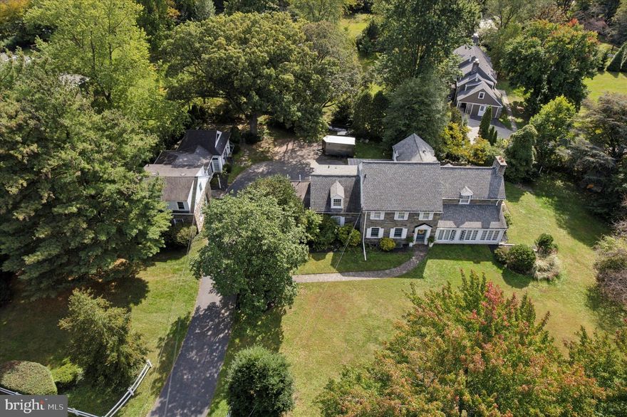 Step into the grandeur of this residence featuring five spacious bedrooms and four elegantly appointed bathrooms. The heart of the home is its expansive living room, complete with a cozy fireplace framed by refined built-ins. Architectural details such as columns, crown mouldings, and decorative mouldings add to the sophisticated ambiance. The double staircase provides an elegant transition between levels, leading to a luxurious primary ensuite with a separate shower and a generous walk-in closet.

This home is designed for both comfort and style, with a full basement offering ample storage and opportunities for customization. Enjoy the charm of exposed brick and the convenience of a private entrance, enhancing both aesthetics and privacy.

Carriage House:
The charming carriage house complements the main residence, offering a large living space with parquet floors and two stately fireplaces. The built-ins and intricate millwork speak to the home's attention to detail and craftsmanship. An impressive family room, filled with natural light from numerous windows, features a gas log marble surround fireplace and opens to a serene flagstone patio.

This unique estate, built in 1926, is a fusion of historic allure and modern amenities, all just minutes from local conveniences and transport links. The main house offers 3,973 square feet of refined living space, perfect for those seeking a harmonious blend of elegance and functionality.

For those desiring an estate that is both a sanctuary and a statement, 501 College Avenue is unparalleled. For more details and to explore this captivating property further, please contact a local real estate professional.