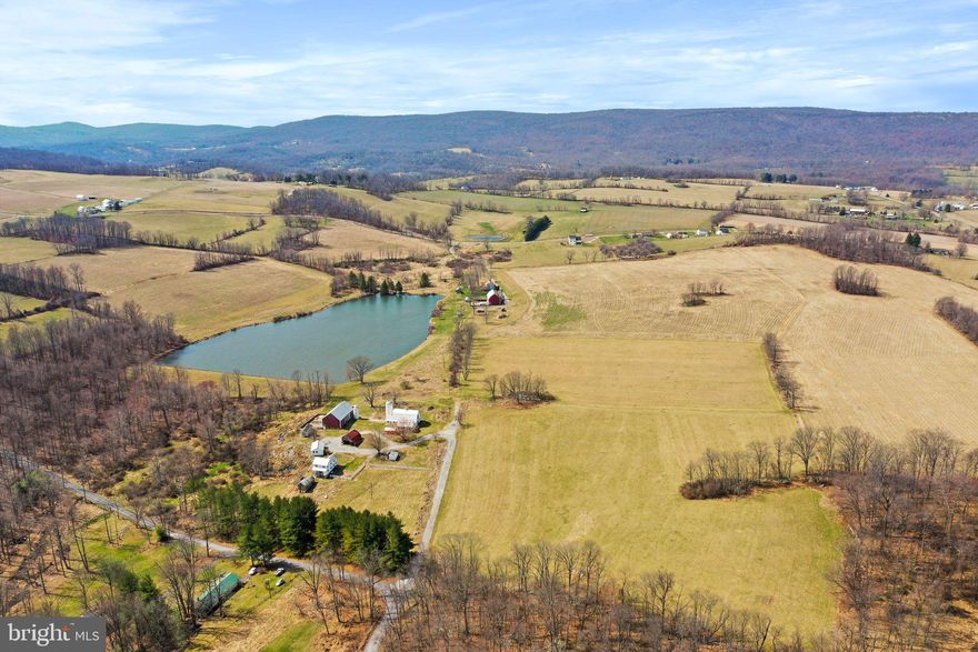 Are you looking for a picturesque property with plenty of acreage? Look no further than this 27+ acre farm, which offers an ideal combination of natural beauty and functionality. This idyllic setting is perfect for anyone looking to escape the hustle and bustle of city life and embrace a simpler way of life. Nestled in the heart of picturesque countryside, this farm boasts stunning views of the surrounding rolling hills along with a neighboring pond. The fertile land is ideal for a variety of agricultural activities, including crop cultivation, livestock farming, or even equestrian pursuits. The acreage provides plenty of space for everything you need to fulfill your farming dreams.In addition to its agricultural potential, the 27+ acre farm also features a charming farmhouse, which has been recently renovated and upgraded to maintain a comfortable and modern standard of living. The spacious interior features a bright and welcoming living area, updated kitchen and bathroom along with handmade woodtrim/doors throughout the home. When it comes to being able to farm,  everything is ready to begin! This property offers unique features like a bank barn, chicken coop, chicken house, dairy barn, and summer kitchen which add charm and functionality to the property.  The bank barn could provides historical architecture or extra storage space for equipment or livestock. The chicken coop and chicken house could be used to start your own small-scale poultry operation or simply enjoy the benefits of farm-fresh eggs. The dairy barn could be used for dairy farming or converting the space into a workshop or event venue. If charm and historical architecture are what you're looking for, this is the home for you! 27 + acres includes two buildable lots, too!!!!