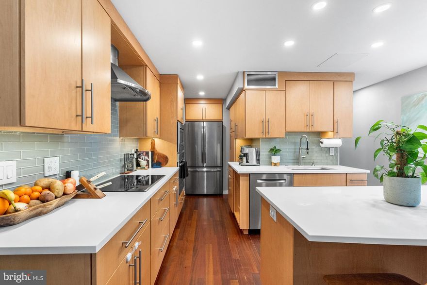 Welcome to 918–20 Spruce Street, Unit 2. Nestled in the heart of Philadelphia’s sought-after WASHINGTON SQUARE WEST neighborhood, this PET-FRIENDLY TWO-BEDROOM, TWO-BATHROOM condo offers a seamless blend of luxury and modern convenience—complete with a private, deeded PARKING SPACE. Enter through a double-door entryway, ideal for effortless package delivery. Unit 2 is quietly positioned at the rear of the building on the main level. Inside, the BI-LEVEL layout immediately impresses with SOARING 20-FOOT CEILINGS and an abundance of natural light. The main level features an OPEN-CONCEPT living space designed for both everyday living and entertaining. The chef’s kitchen is a true centerpiece, showcasing LIGHT OAK SOFT-CLOSE CABINETRY, SLEEK WHITE QUARTZ COUNTERTOPS, and an OVERSIZED ISLAND perfect for prep or gathering. STAINLESS STEEL APPLIANCES—including a cooktop, built in microwave and oven, and a dishwasher—complement the space. Flowing directly from the kitchen, the living area opens to a PRIVATE PATIO—ideal for indoor-outdoor entertaining—with access to a shared courtyard and community garden. This level also includes a spacious bedroom with a distinctive BRICK ARCHWAY and a full bathroom. Upstairs, a versatile BONUS AREA offers the perfect space for a home office, reading nook, or lounge, complete with custom BUILT-IN STORAGE. Down the hall, the generously sized primary suite features a WALK-IN CLOSET and a second full bathroom. A conveniently located WASHER AND DRYER sit just outside the suite, and a private exterior door provides direct access to your deeded parking space. Beyond the home itself, the location is exceptional. Enjoy walkable access to WASHINGTON SQUARE, renowned dining, boutique shopping, theaters, and historic landmarks. Just minutes from Temple University Hospital, Jefferson and Pennsylvania Hospitals, this residence is ideal for professionals seeking both convenience and a vibrant city lifestyle. Public transportation is easily accessible, with the Broad Street Line and multiple bus routes just a short walk away.