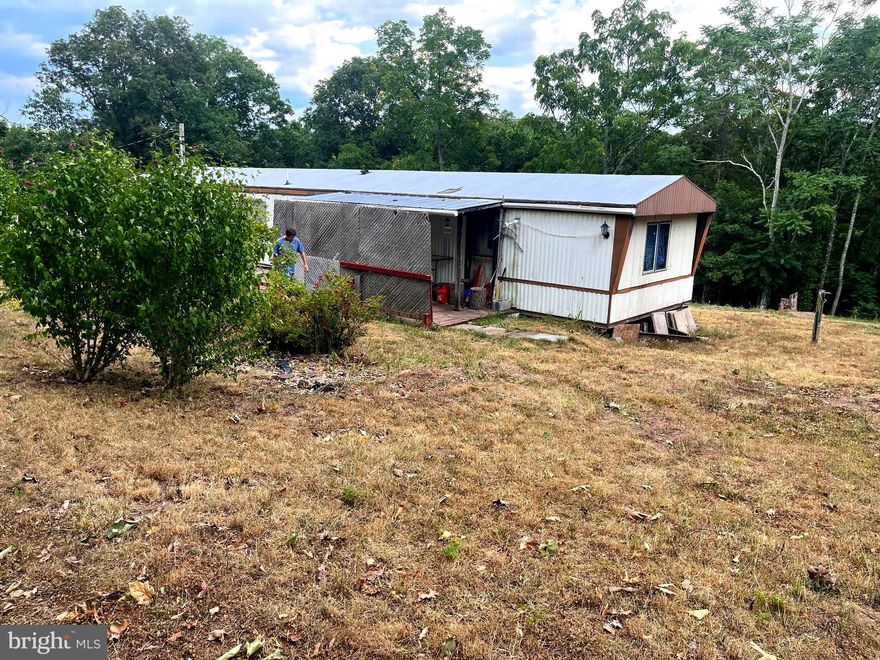 LOCATED ON 2.18 ACRES IN A QUAINT, QUIET AREA WITH VARIOUS STYLES OF HOMES, WITH FULL-TIME OWNERS AND WEEKENDERS, TO GET AWAY FROM THE METROPOLITAN AREAS.  LOCATED IN POTOMAC HIGHLAND FARMS. THE SINGLE-WIDE NEEDS REMODELED INSIDE.  PLENTY OF STORAGE W/ A 2-CAR GARAGE WITH ELECTRIC AND WOOD STOVE.  IF WANTED, REMOVE THE MOBILE HOME AND BUILD YOUR OWN CABIN! AN ADDITIONAL SHED CONVEYS.  WELL & SEPTIC ON PROPERTY. OWNER HAS PLANTED VARIOUS FRUIT TREES.  GREAT FOR GARDENING.  WOODED IN BACK OF THE MOBILE HOME, LOCATED AT THE END OF THE LANE.  THE INTERIOR HAS AN OPEN FLOOR PLAN WITH THE KITCHEN / DINING / LIVING AREA COMBINED.  1 FULL BATH.  SEPARATE LAUNDRY AREA W/ WASHER & DRYER (CONVEYS).  CENTRAL A/C & HEAT PUMP. THE BEDRM IS AT THE FAR END OF THE MOBILE HOME. SELLER IS ONLY TAKING PERSONAL ITEMS.  THERE'S A COVERED PORCH ON THE FRONT AND A DECK ON THE BACK OF THE MOBILE HOME. PROPERTY IS STRICTLY SOLD "AS-IS".  NO ROAD MAINTENANCE FEES, NO HOA FEES.  OWNER IS RELOCATING TO MD.  APPROX. 2 HRS TO THE DC/METRO AREAS.