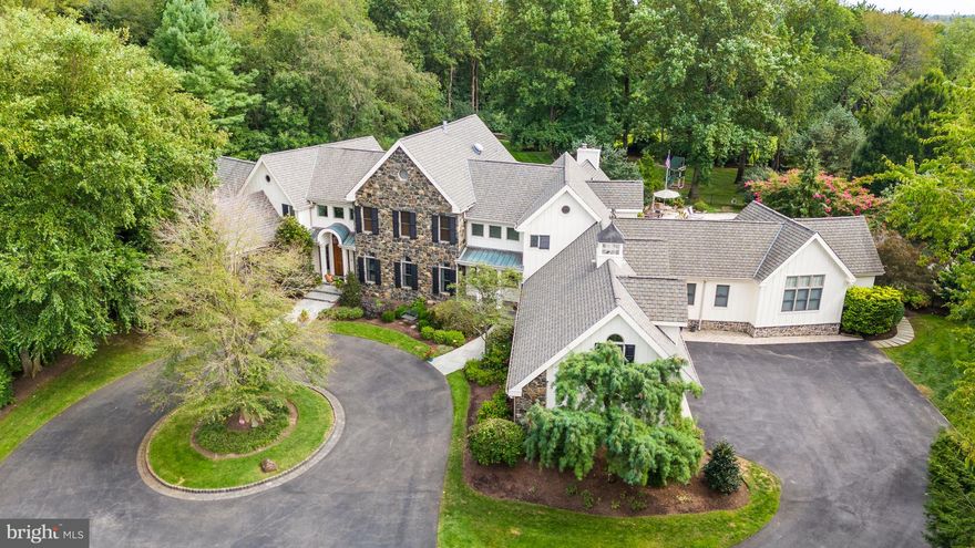 Welcome to Stoney Run in Greenville. Stunning custom French Country style home, compete with circular drive, sits upon private 3.1 acre lot and the end of the cul-de-sac. The two story foyer features a turned staircase together with a view to the backyard.  Both the formal Living and Dining rooms are off the main hall.  The Dining room features a butler's pantry complete with wet bar, wine refrigerator and glass front cabinetry. Both rooms have hardwood floors and crown molding. You will find the first of four gas fireplaces is in the Living room which shares a double sided fireplace with the Dining room.. No detail was spared in the spacious dine-in gourmet Kitchen which was recently done by Waterbury Kitchens in 2022 and is well appointed featuring custom 42' cabinetry, Dolomite counter tops and back splash and high-end appliances. There is a Thermador refrigerator/ freezer, 2 Subzero refrigerator drawers, a Wolf six burner gas range with stainless steel hood, two warming drawers and double wall oven. The large island has a built-in microwave, built-in ice maker, prep sink, pendant lighting and seats four. The eat-in Kitchen has a dining area with a custom built-in blue cabinet featuring two Sub-Zero refrigerator drawers. The Kitchen provides access to the terrace, the pool and the outdoor stone & brick fireplace. The large main level laundry room is convenient to the Kitchen and provides additional pantry storage. Pocket doors from the Kitchen lead into the Family room which has cathedral ceilings, skylights and floor to ceiling stone gas fireplace. Sliding glass doors lead to the private paver terrace with a stone & brick fireplace and heated salt water pool. The beautiful "Park" like rear yard has an irrigation system and is professionally landscaped and is bordered by trees. Off the other side of the Kitchen is 2nd. half bathroom, the back staircase, a second home office and the entrance to the 4 car heated garage. Down the hall is the media/game room which has surround sound and an attached full bathroom which also provides access to the terrace and the pool area. A spiral staircase leads to the lower level gym. The opposite wing of the home features a large office and the luxurious first floor primary bedroom suite. The office has a gas fireplace, built-in cabinetry as well as a vaulted ceiling. The spacious primary suite is well appointed with two large walk-in closets and luxurious four-piece en-suite bathroom. The bathroom offers amenities including a gas fireplace,Whirlpool bathtub, and a steam shower. The double steam shower also has a built-in marble bench for relaxing with the steam. The second level of the home has four additional bedrooms all with their own en-suite bathrooms and walk-in closets. All of the bathrooms were renovated within the last five years. The bedrooms all have recessed lighting and ceiling fans. The spacious 44'x16' play/hobby room features a cathedral ceiling an creates plenty of extra living space for activities. We invite you to tour this stunning home and discover the possibilities!