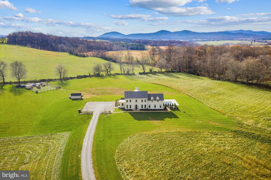 NEW PRICE! Feel a world away from it all in this luxurious stucco retreat just 20 minutes from the historic town of Middleburg. This 6 bedroom, 4.5 bath, 5,200+ square foot home was recently built in 2018 by AAA contractor Gretchen Yahn with the highest quality materials. Enjoy meaningful moments and fireside chats with your friends and family in the large, open kitchen and living room with ample space and seating areas for everyone to dine and relax. The kitchen is exquisite with top of the line appliances, a double oven, oversized refrigerator and quartz Island with seating for 6. Just off the kitchen is a cozy dining room, perfect for family dinners! The 12 ft ceilings and large windows throughout usher in natural light and 360 degree views of the Blue Ridge mountains. The custom cabinetry, custom hardwood floors and marble countertops in all bathrooms are gorgeous. Relax and unwind in the main floor master suite offering a seating area, large closet with custom built-ins, private access to the pool and patio, and bathroom with marble countertops, double vanity, and a glass-enclosed shower with "waterfall" showerhead. Working from home is a delight in the main floor office or fully finished basement. Upstairs you'll find 5 bedrooms, 4 of which have "Jack and Jill" bathrooms and 1 with it's own private bathroom. As you venture outdoors, you are greeted with a large in-ground pool surrounded by a flagstone patio, english gardens, raised beds, AAA fort Knox Chicken coop with electricity and water and easy access to the Orange County hunt ride out. The main level laundry, full service generator, 100 gal/min well, and slate roof are other highlights of this incredible home!