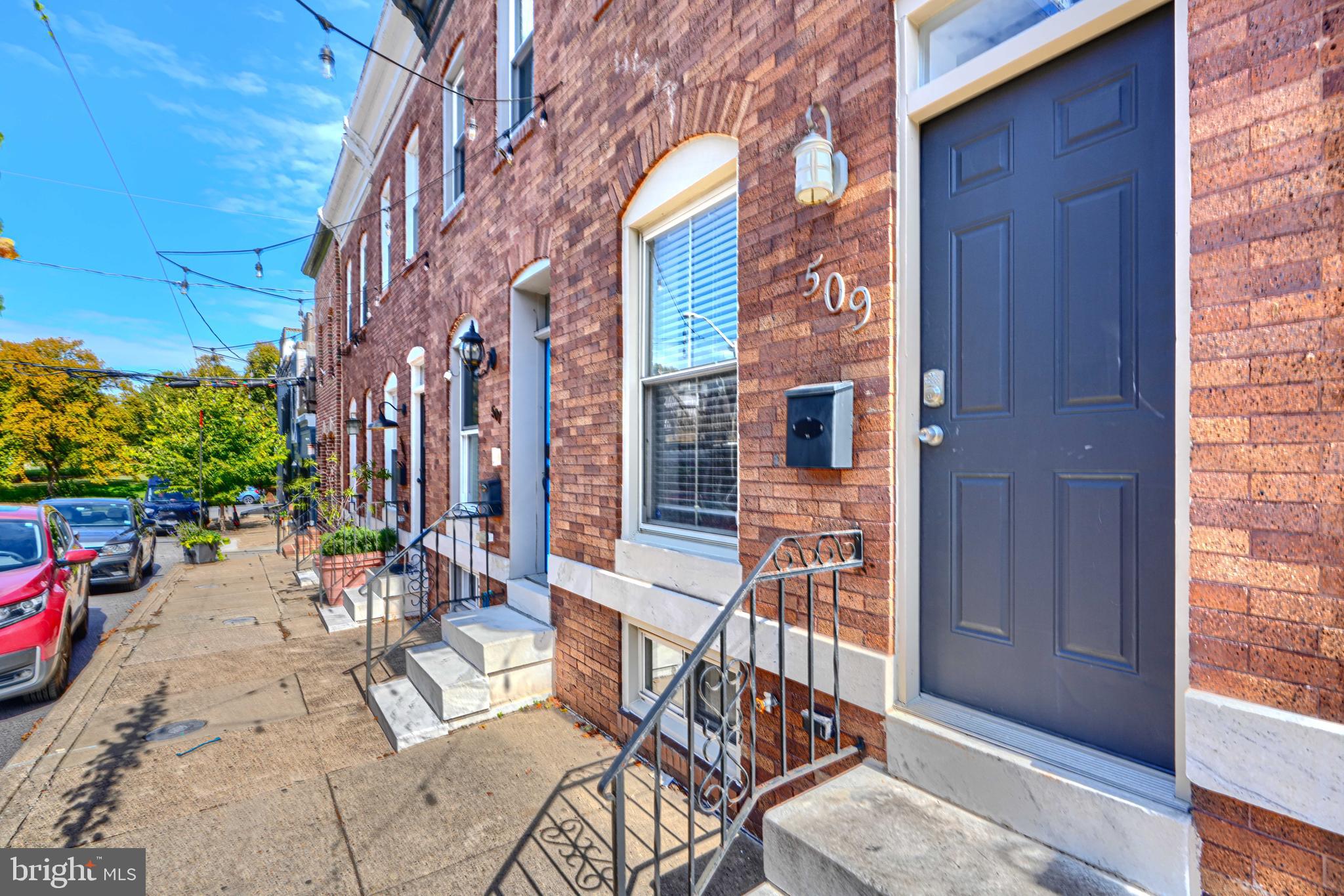 Welcome to this beautifully updated three-level home with rooftop deck and parking pad in the heart of Canton. This 3-bedroom, 3-full-bath residence combines modern design with classic Baltimore charm - featuring exposed brick walls, hardwood floors, and a floating staircase that enhances the home’s open and airy feel. The main level boasts a spacious living area that flows into the large, modern kitchen, complete with stainless steel appliances, granite countertops, coffee bar, single deep sink, abundant cabinet space, and bonus island perfect for entertaining or everyday meals. Upstairs, you’ll find two generous bedrooms, each with great natural light and ample closets. The front primary bedroom features a private en-suite bath and elegant ceiling detail, while the hall bath offers a sleek tile-surround shower with glass door. The finished lower level includes a third bedroom and third full bath — ideal for guests, a home office, or additional living space. You’ll also find a laundry area, storage nook, and utility room on this level. Head to the top floor landing and step out onto your private rooftop deck, where you can relax and take in sweeping city views — including nearby Patterson Park. Out back, enjoy the convenience of your paved parking pad.Located just minutes from Canton Square, the waterfront, and top local dining and shops, easy access to 95, Eastern Ave and downtown. Set up a showing today!