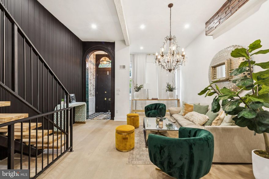 From the moment you step foot into this extraordinary home, you will feel transported to a place of magnificence and excellence. This meticulously designed, stunningly appointed 4 bedroom /4.5 bath home nestled on a coveted block in Spring Garden, is simply breathtaking and features only the finest of materials. Offering a warm & inviting open floor plan concept that includes the sun drenched, south facing living room showcasing soaring ceiling height, a decorative mantel with a striking rope design above, and gorgeous hardwood floors. The open & airy dining room with exposed brick wall is right off the absolutely spectacular kitchen with stunning custom cabinetry, sleek quartz counter tops, state-of-the-art appliances & a dramatic picture window that overlooks the lovely private patio. The power room completes this level. The second floor features a spacious rear bedroom suite with a private bathroom, a decorative fireplace mantel & a large bay window. The large front bedroom houses the beautifully restored original classic armoire, and the hallway bathroom is exquisite. The large laundry room is conveniently located on this floor. Ascending to the third floor, there is a grand sized master bedroom suite with a luxurious master bathroom, and a generously sized front bedroom with its own very large private bathroom. Located in the heart of the Art Museum Area, this 3000+ square foot (includes 250 sq. ft of the finished basement space), exceptional home is within close walking distance to scenic Kelly Drive, The Parkway, Whole Foods, Fairmount Ave, the museums and to Center City.