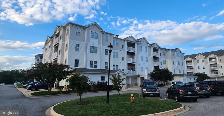 Welcome home  to this spacious condo conveniently located near shopping, restaurants, entertainment and PAX River Naval Base. Corner unit features open floor plan with great living space, kitchen with pantry, plenty of cabinet space and a breakfast bar. There is an office/other room, laundry room, private balcony and 1 car garage, #15, with extra parking in the driveway. Condo has building security entry, main lobby and elevator. Condo fee includes water, sewer, trash, lawn maintenace, snow removal and use of clubhouse with fitness center. Enjoy maintenance free living!  This property may qualify for Seller Financing (Vendee). If property was built prior to 1978, Lead Based Paint Potentially Exists. Sold AS IS.