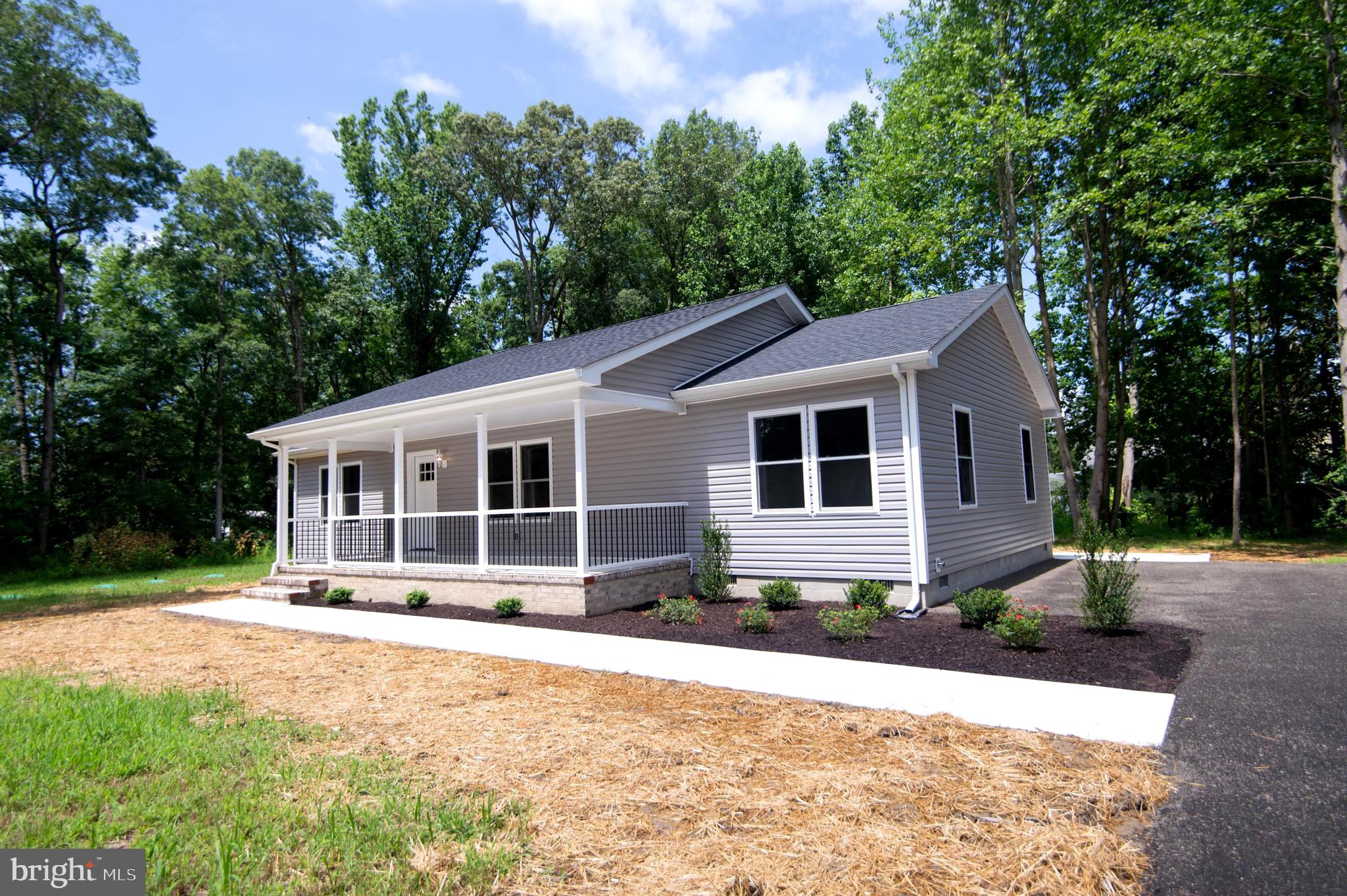 **New Construction - Move-In Ready!**
Welcome to your dream home, a stunning new construction rancher that is ready for you to move in! Nestled on a private, wooded lot that spans over 2 acres, this charming residence features three spacious bedrooms and two full bathrooms.
As you arrive, a generous covered porch invites you to relax and enjoy your morning coffee while taking in the tranquil scenery.
Step inside to find an open floor plan that radiates warmth and brightness, enhanced by impressive cathedral ceilings throughout the living spaces. The thoughtfully designed kitchen is a culinary enthusiast's dream, boasting 42-inch cabinetry, sophisticated quartz countertops, and stainless-steel appliances. The expansive kitchen island serves as an ideal gathering spot for entertaining family and friends. Natural light floods the dining room through sliding patio doors, elevating your dining experience. The large family room acts as the heart of the home, providing ample space for relaxation and connection.
Retreat to the owner's suite, which features an elegant tray ceiling with recessed lighting and dual walk-in closets for abundant storage. The luxurious owner's bathroom is equipped with a walk-in shower, double vanity sinks, quartz countertops, and a separate water closet for added privacy.
On the opposite side of the home, you’ll find two guest bedrooms conveniently situated near a full bath, complete with beautiful quartz countertops.
A dedicated laundry room and mudroom are conveniently located just off the rear deck, ensuring easy access and making laundry tasks effortless. This thoughtful design allows for a seamless transition between outdoor activities and household chores, promoting organization and efficiency. Whether you’re returning from a day in the sun or managing daily laundry, this setup is tailored for your convenience.
Step outside to discover a spacious, maintenance-free deck, perfect for birdwatching or hosting outdoor barbecues, allowing you to fully embrace the serene surroundings. The property also boasts fresh landscaping, a concrete patio, and walkways that complement the outdoor space.
Don’t miss the opportunity to claim this beautiful new construction home as your own—schedule a visit today!