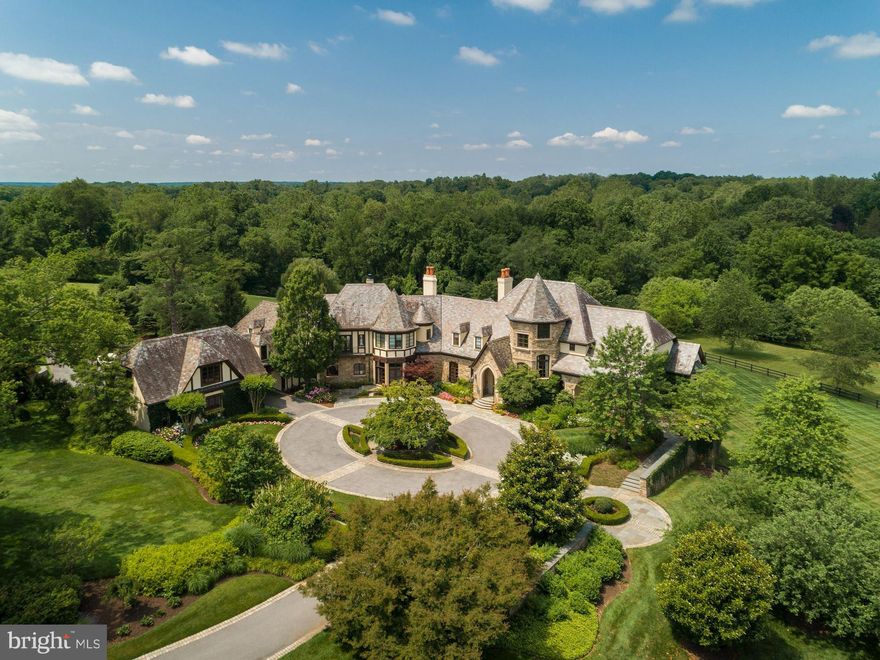 Located on one of the most coveted streets in Potomac, this fairy tale estate on 10 acres is an architectural masterpiece. A circular auto court and professionally landscaped grounds introduce an impressive stone facade with limestone accents. Custom built by Brendan O'Neill and boasting 6 bedrooms/8.5 baths, six fireplaces and 5 car garage, extraordinary workmanship and materials abound. Vaulted ceilings, elegant archways, custom millwork and panoramic vistas from every room.

The home's entry provides immediate impact: Jerusalem Limestone flooring, a massive staircase with custom walnut balustrade and newel post, and 14' ceilings. The Main Level provides two stately home offices, a junior primary suite, dramatic step-down salon, grand Dining Room, and stunning double volume great room with floor to ceiling Palladian windows. A chef's kitchen with adjoining butler's pantry includes high end appliances, designer finishes, informal dining space and a cozy fireside seating area. Enhancing the home's functionality are a generous command center, walk-in pantries, gear storage closets, and robust mudroom.

Ascend to the Upper Level via one of three stairways - one of which is hidden! The primary suite is simply sublime with its own balcony, fireplace, spa-like bath, dual walk in closets and private sitting room. Four secondary bedrooms, an upstairs homework/study space and laundry room complete the Upper Level.

The walkout Lower Level provides endless recreation opportunities from the sports/basketball court, to an oversized home gym, sauna, future wine cellar and copious space for movies, television and games. Opportunities for outdoor entertaining and relaxation abound. A fabulous covered loggia with oversized outdoor fireplace provides three season dining and enjoyment. Numerous patios and hidden terraces allow contemplation of the panoramic vistas and specimen plantings from every angle. Truly the most special offering currently available in Potomac.