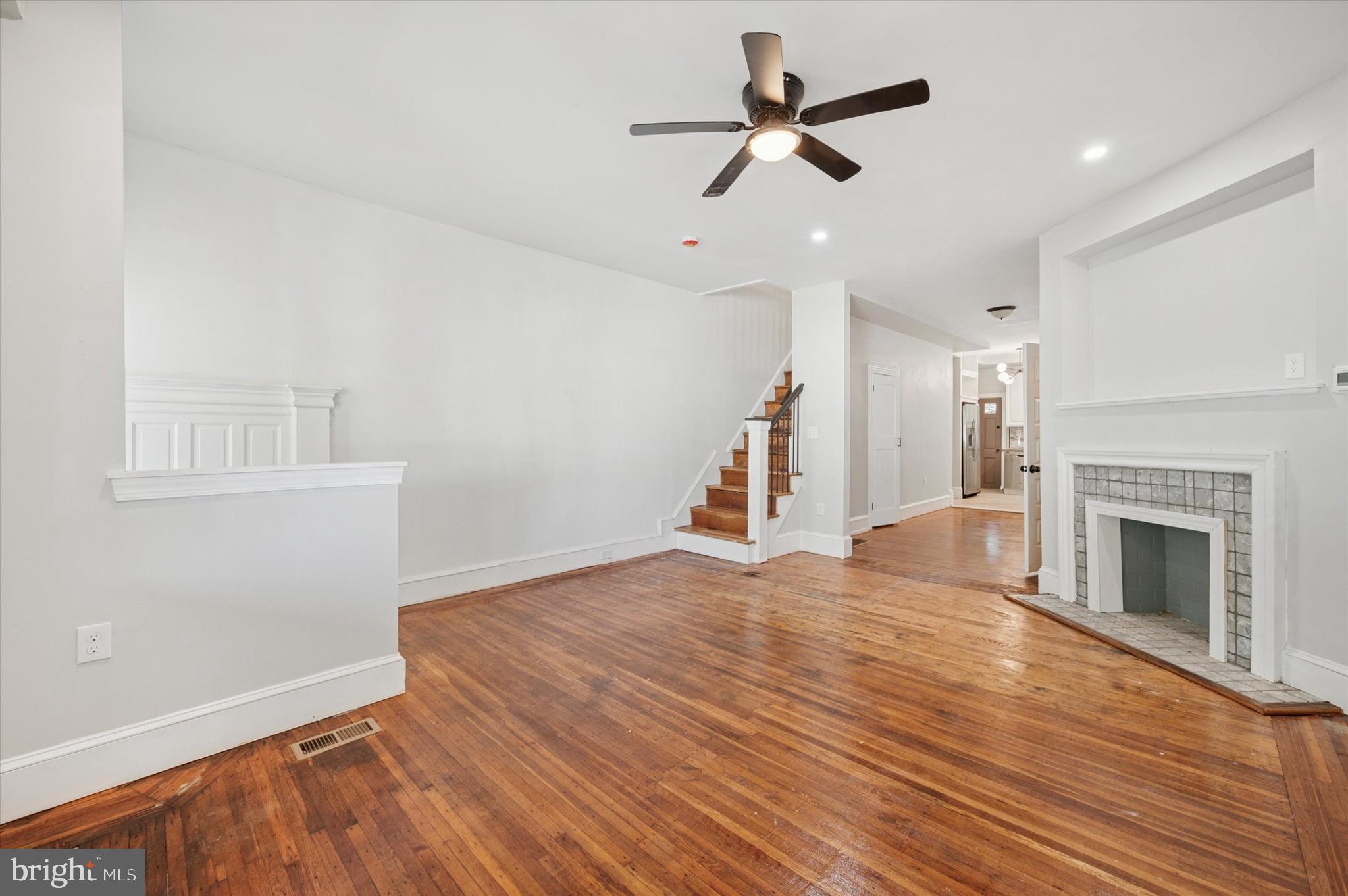 Hand-picked finishes and custom handcrafted details that didn’t come at the expense of this home’s historic charm are the standout features in this thoughtful renovation. Set back from the street behind a garden, the exterior has classic rowhome features: an extra-deep stone porchfront with decorative column and original front door beneath an upper-floor bay window with decorative trim. Inside, much of the original woodwork is intact, and lovely narrow-width oak floors with inlay run throughout. The living room has a pair of oversized front windows, decorative fireplace and some of the original vestibule wainscoting preserved as an ornamental element. A powder room creates some separation between the living and dining rooms; it has a vanity with concrete sink and Vigo basin custom made for the space from a salvaged dresser drawer. The dining room has a sweet vintage-inspired light fixture and an extra-large coat and storage closet. It’s wide open to the kitchen, which is not the same old cookie-cutter look you’ve seen in so many other houses. There are white solid wood cabinets with a handcrafted detailed endcap that’s a subtle nod to the home’s history; open corner shelving; concrete countertops with an extra-wide stainless steel sink; an MCM-style atomic light chandelier; large-format porcelain tile floor and veined backsplash; and stainless steel GE and Whirlpool appliances including a five-burner range. A window with an extra-deep sill above the sink begs for an indoor herb garden. Out back there's a new porch with steps down to the large-for-the-city yard. Upstairs the primary suite is a large room with a bay window and an enormous closet that runs nearly the full length of the room. The en-suite bathroom has an oversized concrete-topped salvaged vanity with Vigo basin sink and stacked elongated subway tile backsplash. The large walk-in shower has white hex tile floors and a custom surround with white elongated subway tile topped with veined porcelain slabs. The large rear bedroom has two exposures, one from a window flanked by closets with original mirrored doors. The middle bedroom more than qualifies as such, with a window, closet and ample space for a full size bed. They share a hall bath that has large-format porcelain tile flooring and tub surround and a vanity with trough-style sink and Vigo oil rubbed bronze hardware. This nice wide, garden-lined Logan block is convenient to Broad St and the Boulevard, plus two parks: 10-acre Hunting Park Rec Center with a pool, sports facilities, farmer’s market and other community activities; and Barrett Playground, which is currently undergoing major upgrades.