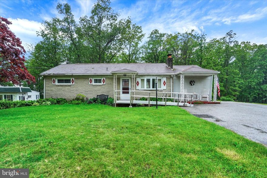 Brick rancher situated on a beautiful rural 1/2 ac lot in desirable Dallastown Schools! Living Room with hardwood floors, a Fireplace with built-in shelves on each side, Bow window & recessed lighting! The Kitchen needs updated, but has plenty of space to work with. There are painted wood cabinets, a double bowl stainless steel sink, chair rail with wainscoting & vinyl floors.  The stove, refrigerator & dishwasher are all included with the sale. The vinyl floors continue into the large Dining Area which has room enough for a fully expanded dining room table, hutch & more...a great place for large family dinners! This room also offers large casement windows for lots of natural light, a ceiling fan & glass doors that lead out to the deck & large backyard! (Note: Deck needs work!) There are 3 bedrooms & a full bath. The bathroom has a pedestal sink, vinyl floors, wainscoting with chair rail & a tub/shower unit.  All 3 Bedrooms have hardwood  floors. The front Bedroom has a closet with a stackable washer & dryer that are included with the sale. The lower level has some walls erected & with some work could be finished for future living space. There is an outside entrance to the basement & another Fireplace on this level. A great opportunity to own a home in a beautiful location just minutes to I-83 & all conveniences.  This home needs some work but offers lots of possibilities to build some sweat equity!! Take a look today!