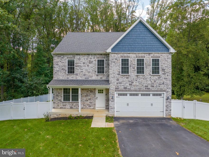 Welcome to 2840 Ridge Road – a spectacular colonial home with over 3,500 square feet of luxurious living space with four bedrooms, set on a 1.83 acre lot that backs to trees. This exquisite home offers a harmonious blend of classic elegance and modern design, making it a dream home for those seeking both style and functionality. With hardwood floors and crown molding throughout the main level, a modern neutral color scheme, soaring ceilings, and impeccable finishes, this home is a true masterpiece.  As you enter, the living and dining rooms provide plenty of space for entertaining guests and set the stage for timeless sophistication. The gourmet eat-in kitchen is a culinary enthusiast’s paradise, featuring sleek stainless steel appliances, elegant quartz countertops, a stunning waterfall center island, a convenient breakfast bar, 42” cabinets with undermount lighting, decorative glass backsplash, and two pantries. The adjacent breakfast room provides direct access to the expansive deck, making it a delightful spot for enjoying morning coffee or outdoor dining. The family room, conveniently set off the kitchen, is anchored by a cozy gas fireplace, creating a warm and inviting space for relaxation and gatherings with loved ones. Upstairs, the spacious primary bedroom suite is a true retreat and boasts two walk-in closets. The luxurious private bathroom is adorned with a soaking slipper tub, a dual sink vanity, a separate water closet, and two frameless glass-enclosed walk-in showers. Three additional bedrooms, a second full bathroom and a convenient laundry closet finish the upper level. Downstairs, the walk-out lower level is an entertainer’s dream, with a massive game room complete with a wet bar that makes this the perfect spot for hosting parties and watching your favorite movies, or the big game. An additional full bath on this level adds convenience, and there is plenty of storage space for all your belongings. The fully-fenced rear yard offers privacy and tons of space for everyone’s outdoor activities. 2840 Ridge Road is not just a house - it is a statement of luxury living. With its grandeur, attention to detail, and thoughtful layout, this home is a true masterpiece that provides both comfort and style with a private location. Excellent location close to a wide variety of shopping, dining, entertainment options and major routes. Built in 2020 with a ten year builder warranty, no homeowners association and no front foot fee.