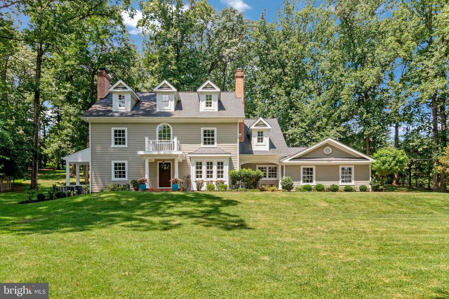 Set on a 1.37-acre lot on one of McLean’s most beautiful and sought-after streets amidst mature trees and newly built mansions, this gorgeous, classic home offers just under 5,000 square feet of updated living space ready for immediate move-in. Featuring smart details and updates, an open floor plan, hardwood floors, and elegant moldings, the home blends architectural details with comfortable, well-designed living spaces.

A brick walkway welcomes you to this charming New England style home with a covered front entry. The natural light filled two-story foyer is flanked by a large living room with fireplace and sizable elegant dining room - ideal for entertaining. An office with built-ins is tucked away in the back of the home overlooking the peaceful backyard, providing a private workspace with natural light.  The family room features large windows, a stone fireplace, and views of the backyard, creating a bright and relaxing space. The kitchen is designed with granite counters, an island with seating, glass display cabinets, and high-end appliances including a refrigerator, dishwasher, and gas stove with vent hood. Adjacent is a spacious breakfast room complete with a chandelier and its own fireplace - perfect for casual dining.  A large mudroom with incredible storage leads to a modern attached two-car garage. 

Upstairs, the primary bedroom has views of the expansive back yard, two walk-in closets and an en-suite primary bathroom with granite counters, separate vanities, a glass shower, and separate tub.  The upper level includes three additional bedrooms - one with an ensuite bathroom and two with a Jack-n-Jill full bath. A laundry room with full-size washer, dryer, storage shelf and clothes hanging space completes this level.  The second upper level has two more bedrooms and a bathroom, suitable for guest bedrooms or home offices.  The lower level features a spacious recreation room, full bathroom, storage area, and a walk-up exit to the side yard.

The lush landscaped grounds showcase a brick front walkway, covered patio with lighting and fan, stone back patios, a hot tub, and a built-in grill with island, all overlooking a gorgeous serene yard. The property is truly an oasis, close to shopping, airports, restaurants, while also offering a true welcome home escape from the hustle and bustle. Close to Tysons but feels like a vacation get-a-away.

Residents may join and enjoy access to the exclusive Woodside Lake—a private neighborhood lake spanning eight acres, fed by springs and creeks and featuring a sandy beach, a dock, and abundant wildlife.  Woodside Lake is moments away from this home and offers a wonderful community place to swim, kayak, canoe, paddle-board or just relax.  

This home is also located within sought-after Spring Hill Elementary, Cooper Middle, and Langley High School districts, with easy access to Tysons Corner, the Beltway, George Washington Parkway, and the Dulles Access Road.