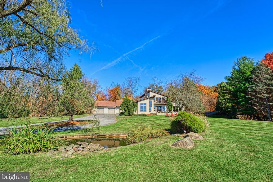 Welcome to this stunning mid-century modern home nestled in the serene countryside of Round Hill, just off historic Snickersville Turnpike and convenient to Rt 7. This fully updated gem boasts an impressive 4,200+ square feet of finished living space, featuring exquisite wood vaulted ceilings that add a sense of grandeur to every room. Situated on over 22 acres of rolling countryside, the property offers breathtaking sunset views of the majestic Blue Ridge Mountains. Step inside and be greeted by the opulent charm that this home exudes. The newly renovated kitchen is a chef's dream, featuring top-of-the-line appliances, sleek countertops, and ample storage space. Whether hosting a formal dinner party or just preparing a quick meal the kitchen is sure to impress. With four spacious bedrooms plus a bonus office, there’s plenty of space for to unwind and relax. The first floor primary bedroom offers a tranquil retreat, complete with an ensuite bathroom, private balcony, large west facing windows and roomy walk-in closet. Wake up to views of the countryside and rejuvenate your senses before starting your day. To further enhance your enjoyment of outside, this property encompasses a tennis court (scheduled for resurfacing into a tennis/pickle ball court), numerous patios, a small pond, creek and paths through the surrounding hardwoods. When it comes to relaxation and wellness, this home has it all. Take a dip in the enclosed lap pool, providing year-round enjoyment and allowing you to stay fit and healthy regardless of the weather. Additionally, a convenient sauna awaits you, offering the perfect place to unwind and detoxify after a long day or cozy up next to one of three fireplaces. Beyond the confines of this exquisite home, the expansive 22+ acre lot offers endless possibilities. Embrace the beauty of the rolling countryside as you embark on scenic walks, picnics, or simply enjoy the peace and tranquility that this property provides. The sprawling views of the Blue Ridge Mountains create a picturesque backdrop that will leave you in awe, truly highlighting the beauty of nature. Located in Round Hill, you will find yourself surrounded by a thriving community that offers a perfect blend of tranquility and convenience. Just a short drive away, discover an array of shopping, wineries, dining, and entertainment options, ensuring that you’re never far from all that you need. Don't miss this incredible opportunity to own a fully updated mid-century modern home with spacious living areas, stunning views, and luxurious amenities, this property is truly a dream come true. Schedule your private tour today and experience the epitome of modern living in Round Hill!