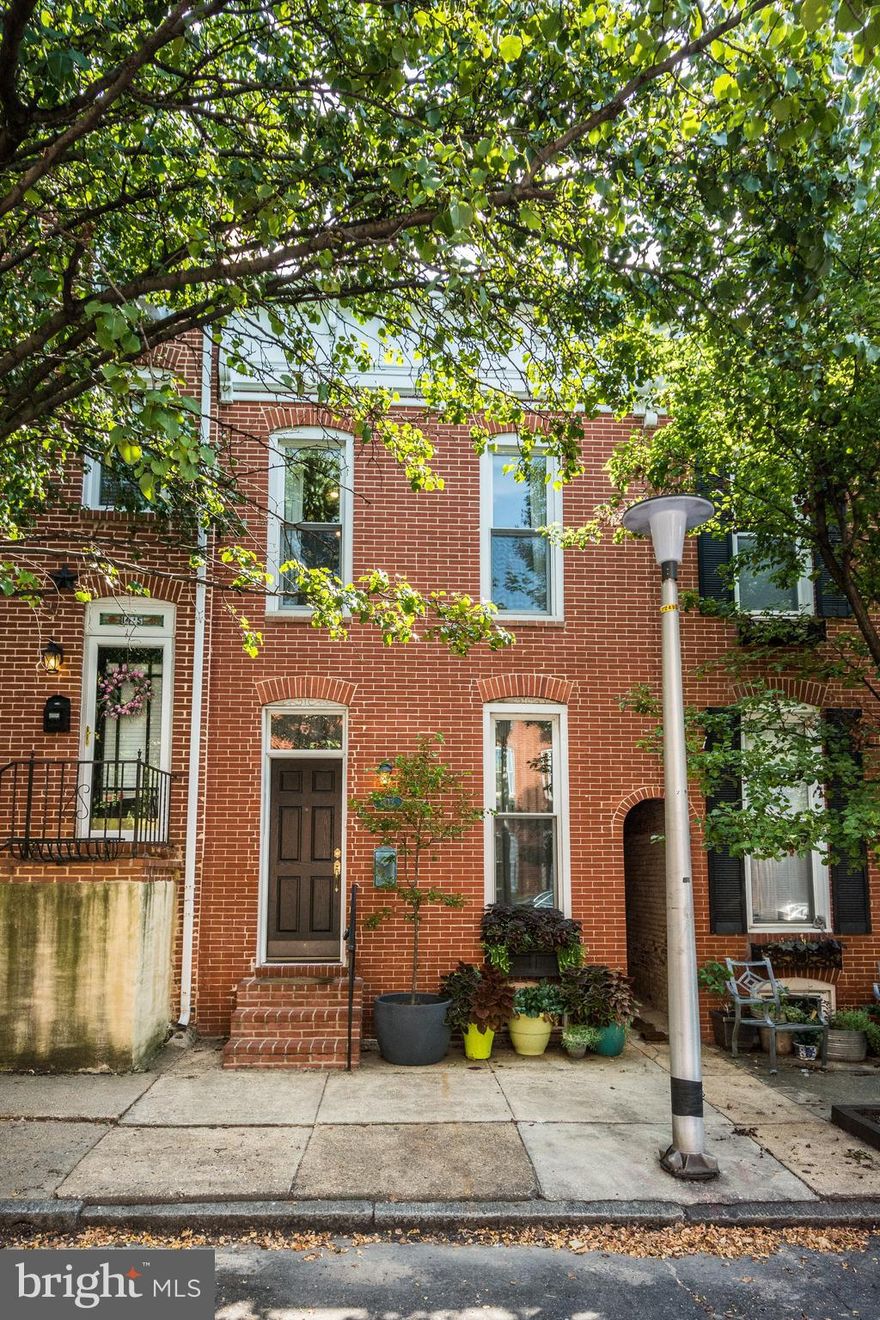 Must see! Inviting curb appeal & large home with open concept main floor.  Gorgeous recently refinished original hardwood floors, warm wood burning fireplace for cozy winter evenings, high ceilings, recessed lighting & more. Quality craftsmanship throughout home including 14  Pella windows, three skylights, letting natural light shine in! Anderson doors at decks & kitchen.  Recently installed hardwood fencing at breezeway with 2 gates. Huge granite kitchen with upgrade stainless steel appliances. Lower cabinets with pull out drawer feature. Breakfast bar & a center island w more sunny windows! Half bath & under stairs storage closet.  Upper level has wide  center hall under 2 story height: plenty of room for office desk and chair! Full size stack laundry, 2 bedrooms with great closet space including loft style storage. Plus rear bedroom has its own deck space. 2 full bathrooms & more of those gorgeous hardwood floors. Open riser staircase leads to roof deck with panoramic city views.  Parking pad can fit 2 compact cars or 1 large SUV.