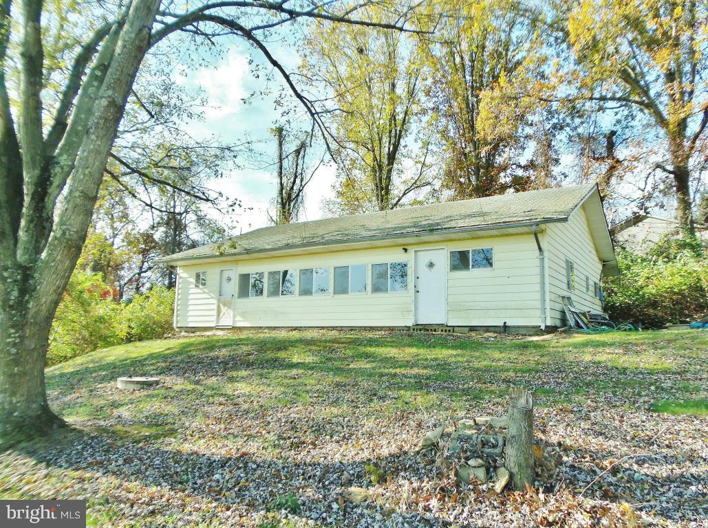 Beautiful 2+ acre improved lot in tranquil country setting! 1970s rancher needs major rehab. Former kitchen and bath were demo'd for future renovation. Well, approved cesspool septic system, and electric on site. Lush grass lawn throughout. Some trees. Slightly sloped lot. Includes new storage shed. Gravel driveway to the property is off Aubel Road, just before the 'For Sale' yard sign.