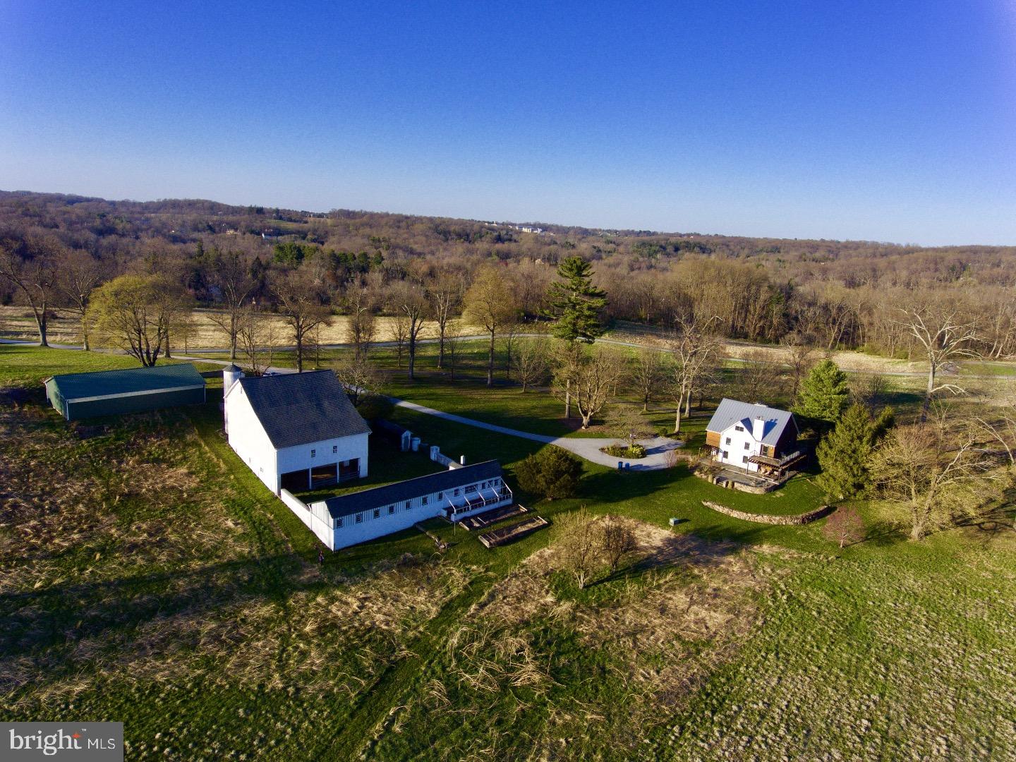 Farmhouse at Summerhill is a fantastic property up a long driveway, with a completely renovated / upgraded / rebuilt home, large Chester County stone bank barn, modern agricultural structure etc. The western view from the house is over a large meadow, of which the house and flagstone patio overlook. The property is in two parcels, totaling 18.78 acres being sold together. Strict conservation easement on 10 acre parcel with Natural Lands. 3 bedrooms, master suite with deck overlooking spectacular long meadow view. Third floor great room offers a cavernous open space that is light and airy, and includes a half bath. Much of the surrounding land is also under conservation easement providing a sense of unmatched tranquility and privacy. This unbeatable Willistown location is convenient to Philadelphia, R5 and Amtrak, Great Valley School District, pvt. schools, and all the Main Line and Radnor Hunt has to offer.