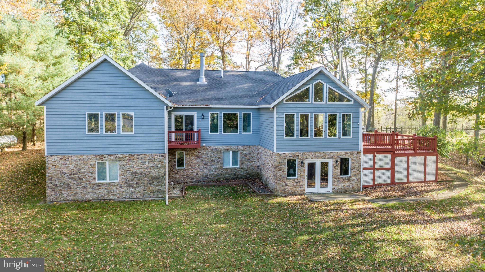This exceptional 5-bedroom, 4.5-bathroom cedar-sided rancher, perched atop Sunset Ridge on a double lot, offers unmatched panoramic views and is located in close proximity to McHenry, Deep Creek Lake, Wisp Resort, and many state parks—a haven for outdoor enthusiasts.
Designed for those who seek both comfort and style, the open floor plan seamlessly blends rustic charm with modern luxury. The home features expansive common living spaces, perfect for entertaining or simply enjoying quiet evenings. The stone fireplace adds warmth and character to the heart of the home, creating a cozy gathering spot. Each of the five bedrooms is spacious and welcoming, while the 4.5 bathrooms are beautifully appointed for convenience and comfort. With easy access to year-round outdoor recreation, this property offers a lifestyle like no other. Don't miss this must-see home that combines stunning views, beautiful design, and high-end features for a truly exceptional living experience. Schedule your private tour today!