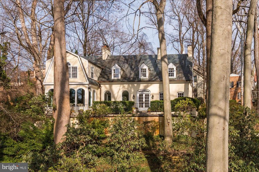 This captivating five-bedroom, four-and-a-half-bathroom home has always been admired as one of the great Westmoreland Hills homes and impresses with a 17,525 square-foot corner lot. The exquisite exterior complements the spacious interior featuring over 4,300 square feet of living space, hardwood floors, oversized windows, and stunning millwork. The main level boasts a library with a cozy fireplace, an oversized living room with an additional fireplace, a sun-filled formal dining room with arched windows, and, next to the kitchen, a family room with a spiral staircase leading upstairs. The gourmet eat-in kitchen is a chef's dream with granite countertops, stainless steel appliances, a center island, a walk-in pantry (with an additional wall oven), and a breakfast nook for informal dining. Completing this level is the welcoming foyer, an additional sitting room with French doors opening up to the back patio, and a powder bathroom. The second floor features four bedrooms and three full bathrooms, including the primary bedroom with an ensuite bathroom and a walk-in closet. An office with built-ins (or potential additional bedroom) and conveniently located laundry complete this level. 

The lower level offers a recreation room, a bedroom with a private outside entrance and full bathroom (making this the perfect in-law or au-pair suite), and a second laundry room. Outside off the main level, an expansive wrap-around patio with a built-in grill is perfect for outdoor entertaining. The property also features over 17,500 square feet of enchanting landscaping, including beautiful gardens, flat yard space, a gazebo, and a stream. A circular driveway with additional parking is ideal for hosting. The home is just steps from Westmoreland Hills Park and Little Falls & Capital Crescent Trails. Starbucks, Millie’s, and the Spring Valley Shopping Center are just up the road! Westmoreland hills is an ideal location being a quick drive to downtown DC, Bethesda, or Chevy Chase. Don't miss the opportunity to make this stunning property your new home!