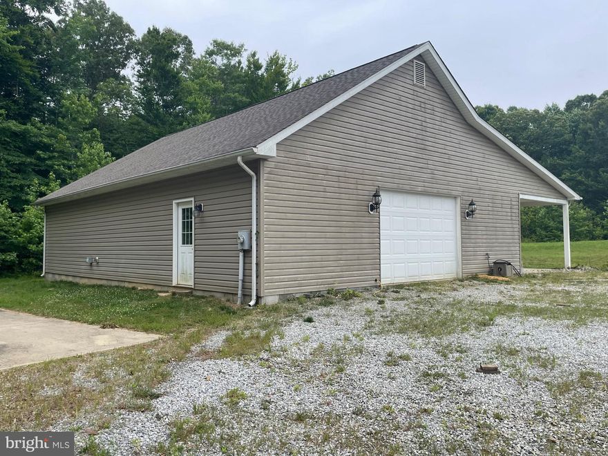 Rare find in this fantastic 9-acre lot in La Plata with 5 car garage/workshop, deep Well and electric already in place. This property has been perced and one acre is already cleared making it an ideal location to build your dream home. One of the standout features of this property is the impressive 36 x 48 detached garage.  The garage is thoughtfully designed with a large bay door, allowing easy access for vehicles and equipment. Inside, the garage is finished with drywall, fluorescent lights, and electric outlets throughout, providing a comfortable and well-lit workspace. The spacious interior can accommodate at least five cars, and there are two finished rooms, one of which is heated. Multiple doors, including a back door and side doors, add to the convenience and functionality of the space. With a vinyl exterior, it is low-maintenance and visually appealing. A large covered patio area, supported by five columns, provides a great space for outdoor relaxation.  Adjacent to the garage is a large concrete pad for parking your RV. There is a holding tank with approximate capacity is 1,000 gallons . This is the perfect setup to live in your RV while your new home is being built. A circular driveway in front of the garage enhances convenience. Additionally, a deep Well has already been installed on the property, ensuring a reliable water source. The Well was installed and the garage was constructed in 2012, ensuring relatively recent construction and modern features. Overall, this property presents an exceptional opportunity to acquire a spacious lot with desirable features such as a well, cleared and wooded areas, a detached garage with numerous amenities, and a convenient location near a small subdivision. Don't miss the chance to explore the possibilities this property offers.