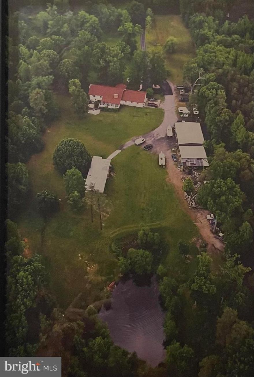 This is an estate sale and a short sale being professionally negotiated.
This is a unique property with huge potential. The property is 6.8 acres with a pond and is private and secluded. The home has 2 rental units in it in addition to the main living area as well as an accessory dwelling unit (mobile home) on the property. Additionally there is a five bay oversized garage (over 2400 square feet) which has a half bath in it.
The main house has three bedrooms and two and a half baths as well as two sunrooms attached. There is also a two bedroom one bath rental unit attached to the main house on the main level. The lower level of the main house has an additional one bedroom rental unit in it. The home consists of over 4,800 square feet so there are a lot of possibilities. 

The property needs updating and is being sold as-is and the estate is making no repairs.