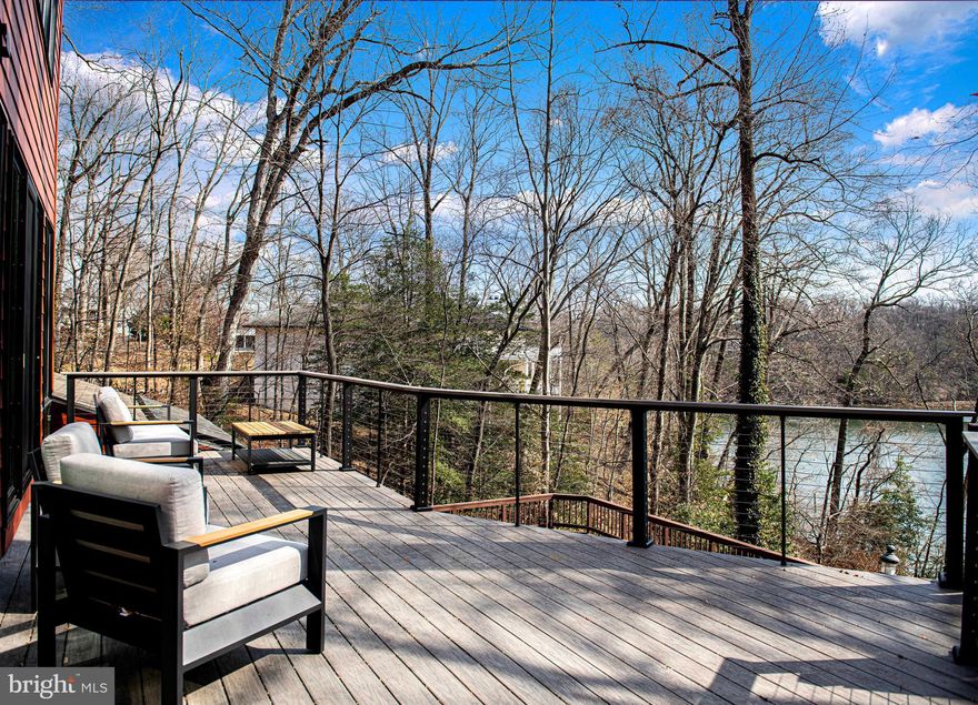 An extraordinary opportunity to own a premier property in The Downs has arrived. This expansive contemporary on almost 2 acres offers over 5,000sqft of open living with direct views of Clements Creek from seven rooms and a 180ft pier. This home has some serious wow factors including; a hexagonal dining room... double entry doors...an enclosed hot tub area with river views...an exquisitely renovated primary bathroom and dressing room suite with radiant heat flooring...new water treatment system with reverse osmosis and UV filtering...a concrete reinforced wine cellar or panic room...a cozy, sunken seating area claims one side of the double-sided gas stone fireplace while the other side of the room offers panoramic views through a huge architectural picture window and sliding glass doors...the list goes on and on. A 3-level spiral staircase with additional views is tucked to one side of the home and accesses the gym, family room and primary bedroom which just adds to its overall uniqueness. Relax at night or wake up in your owners suite with yet another large picture window from the homes highest vantage point with jaw-dropping views of the water and your long, private pier. The pier has been outfitted with reinforced pilings to accommodate a 40,000lb boat lift which has already been permitted and electric has been run to the the end of the pier, one of the longest in the Downs community. Your new home comes with an abundant list of community amenities including a pool, clubhouse, tennis & pickleball courts, a playground and two marinas. Enjoy the perfect mingling of privacy, indoor/outdoor space, water views and an overall sense of a permanent vacation while still being close to Annapolis and with easy access to Baltimore and Washington DC. It truly is a DREAM!