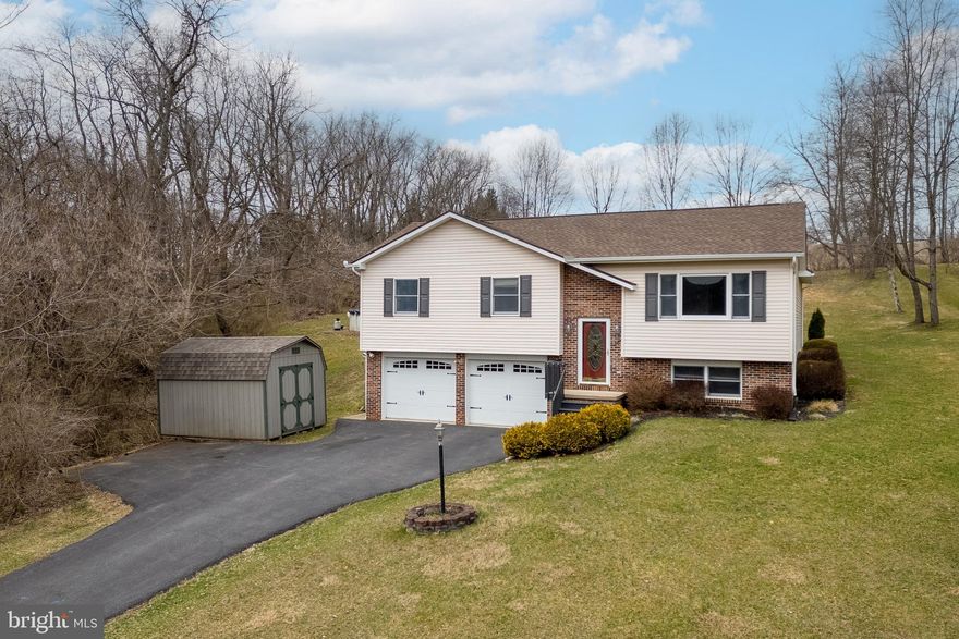 Make memories to last a lifetime in this delightful home in Bellefonte, a nestled in a picturesque location with stunning mountain views. Step into a spacious living area that flows seamlessly into the kitchen, showcasing rich oak cabinetry and a pass-through window that opens to a bright, light-filled family room. The family room, with its vaulted ceilings and cozy fireplace, is the perfect retreat for relaxation. Natural light floods the space, while a door leads to the expansive deck—ideal for enjoying fresh air and easy access to the backyard. The family room seamlessly flows into the dining area, highlighted by parquet hardwood floors. This level also features an owner’s suite with a private bath, along with two additional bedrooms and a full bath. The lower level offers even more living space with a versatile family/rec room and a laundry area. Additional features include a two-car garage, two generously sized storage sheds, and an above-ground pool, surrounded by private woods for a tranquil outdoor escape.