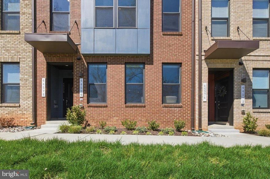 Welcome home to 44576 Wolfhound Square, a stunning, like new townhome style condo in the highly sought after Ashbrook Place community, where modern luxury, premium upgrades, and an unbeatable location come together effortlessly. Built in 2022, this beautifully appointed home offers bright, open living with soaring ceilings, oversized windows, recessed lighting, and wide plank luxury flooring throughout. The main level is designed for effortless entertaining, with a seamless flow from the open living and dining area into a gourmet kitchen featuring a large center island with seating, upgraded white shaker cabinetry, quartz countertops, and premium GE stainless steel appliances including a three door refrigerator, double ovens, electric cooktop with designer hood, built in microwave, quiet dishwasher, and deep sink. A generous pantry, powder room, and direct access to the attached one car garage and private driveway complete the main level, including a garage that features a professionally coated, speckled high durability floor.

Upstairs, the spacious primary suite offers a true retreat with a spa inspired ensuite bath featuring dual vanities, a frameless glass shower, and a separate water closet, plus an oversized walk in closet. A versatile loft opens to a private balcony, perfect for a home office, den, or lounge. The upper level also includes a second bedroom, full bath, and a dedicated laundry closet with stackable LG washer and dryer.

Residents of Ashbrook Place enjoy community green space, picnic areas, and a dog park, all within walking distance to shopping, dining, entertainment, Trader Joe’s, and the year round Loudoun Farmers Market. Major commuter routes, Metro access, and everyday conveniences are just minutes away.

Move in ready, meticulously upgraded, and competitively positioned, this home delivers exceptional value with all the high end finishes buyers want without the wait or added cost of new construction. A rare opportunity to secure one of the best value offerings in the community.