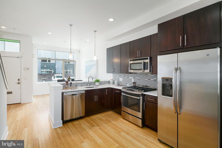 Luxury townhome in the heart of Northern Liberties. As you step into the open concept main floor you are greeted with an abundance of natural light from the large picture windows. The bright and inviting space has separate living and dining areas providing ample space to gather with family and friends. The gourmet kitchen is well-appointed with granite countertops, tile backsplash, dark European cabinetry and stainless steel appliances. With direct access to the private, rear patio from the living room - you can dine alfresco, under the stars! The second floor has two bedrooms, two stylish full bathrooms, plus a laundry room with additional storage and full sized, front loading washer and dryer. The third floor master is an owner s dream! Spacious and sun-drenched with huge walk-in closets and a spa-like bath featuring a walk in, glass shower with dual shower heads. Head downstairs to the large finished basement with tons of space for entertaining! Enjoy hardwood floors and tile throughout. Bonus features include a built in security system and reserved off street parking. Conveniently located to Septa, area restaurants and attractions. All square footage numbers are approximate and include above and below grade measurements. Square footage and taxes are responsibility of the buyer to verify. Photos are of a similar unit.
