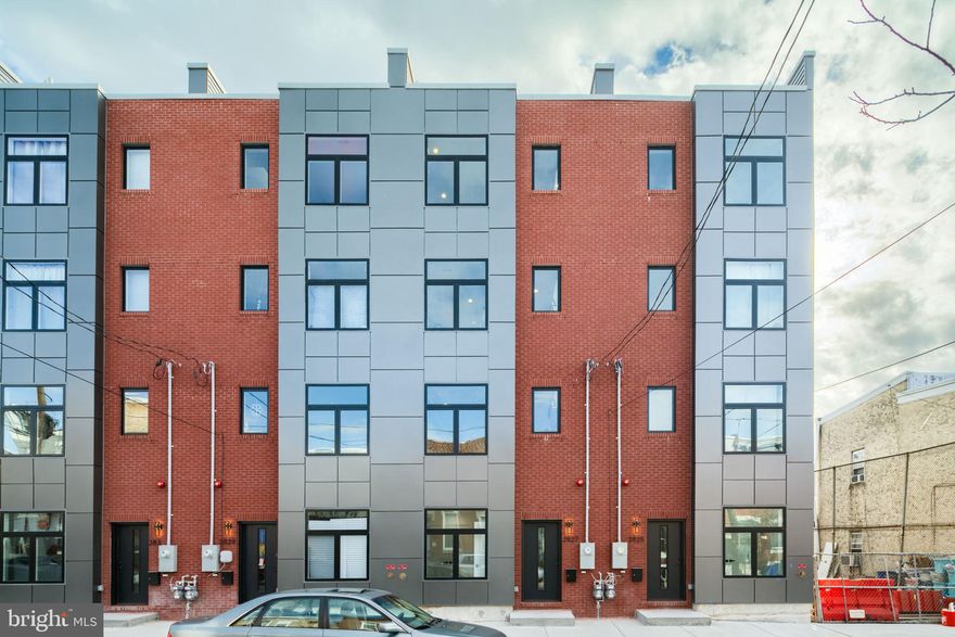 Welcome to this 4 bedroom 2.5 Bathroom townhome in the  School House Commons located in the desirable Port Richmond section of Philadelphia 5 years left on Tax Abatement!! This luxe townhome is 4 stories tall featuring  a 1 car garage and over 2,100 sq ft of finished living space. As you enter through the garage from the common driveway at the rear of the home and walk through the garage door into the house where you will find the first of the four bedrooms. This room is perfect for an office or den. Make your way up the stairs up to the main  floor where you will see the open concept floor plans with living room, dining area and kitchen. The open kitchen features high end appliances, plenty of cabinet space and tons of natural light pouring through the windows. This main floor is ideal for entertaining.  Up on the third floor is the primary bedroom suite with walk in closets and 4 piece bath (shower stall, dual vanity sink, soaking tub and toilet). In the hallway you will find the stackable washer / dryer closet. On the top floor of the home (fourth floor) you will find the additional two bedrooms and full bathroom accessed from the 3rd bedroom as well as  from the hallway.  As you make your way up to the roof top deck you'll be amazed at the views of the Benjamin Franklin Bridge and the Philadelphia Skyline. Location is super walkable in the establishing are with plenty of local stores, restaurants and bars. It's also convenient with access to I95 North and South.  Book your appointment today!