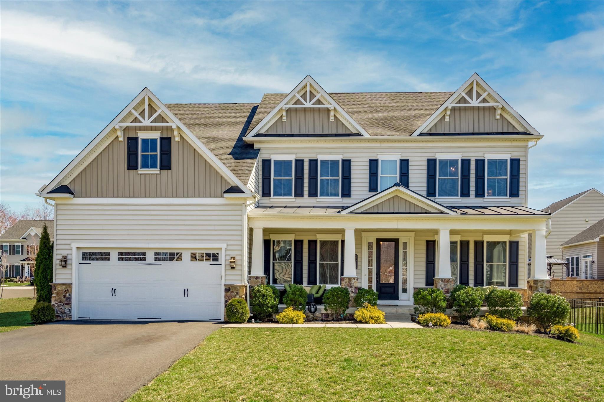 Fall in love with this 5-bedroom, Chapel Hill II Craftsman in the Warrington Springs Community built by NVHomes. Enjoy the peace and quiet of neighborhood living, located on a premium cul-de-sac lot, while having shops, restaurants, golf courses, CB schools and major highways at your fingertips. From the moment you pull up the driveway, you will be impressed with the custom craftsman exterior, a one-of-a kind for the neighborhood. The owners hand selected the color palette, gable-style roofline, full-length porch, and the custom 4 grid design windows. No stone went unturned when it came to the design of this home both inside and out. Not only did the sellers extensively upgrade the home at purchase, they continued that list year after year. The full-length porch is the perfect greeting before entering into the beautiful foyer with 10ft ceilings (found throughout 1st floor).Every upgrade option was accounted for with the woodwork including 6” baseboards, enhanced crown molding, tray ceilings, wainscoting, open box oak treads, and the columns were custom selected. The entry foyer dazzles guests with flanked columns and the formal sitting room and dining room sit adjacent to one another. The hardwood flooring (Armstrong American Scrape Red Oak) starts in the foyer and continues throughout the main level. Continue into the heart of the home to the jaw-dropping, two-story great room. The enhanced window package provides an entire wall of windows that flood the home with sunlight and provide fantastic views overlooking the new paver patio. The gourmet kitchen is open to the great room PLUS Morning Room was added as an upgrade. Easily holds a 10ft+ dining table and makes finished bsmt larger. Striking 42” Timberlake cabinetry pops against the darker lower cabinets of the center island. The cabinetry continues into the butler pantry where a coffee or wine bar could be set up. Stainless steel appliances include a refrigerator, dual wall ovens, gas cooktop and dishwasher. The glass patio doors in the morning room lead to the newly added custom patio including a built-in Lion premium grill, custom bar with leathered granite counters, stunning fireplace, and a Volt lighting package for evening illumination. Back inside the main level you will find a mudroom with built-in bench/lockers, half bath and a home office (flip the hall closet and transform this space into a 1st floor bedroom if desired). After a tiring day, retreat to the primary suite. Take your pick of which dual staircase to use. Enter through the double doors into the spacious bedroom with 3 windows, a tray ceiling, and additional sitting area where you can enjoy your favorite tv show. Two walk-in closets flank the hallway leading to the en suite bath. A luxurious soaking tub sits below the window allowing natural light to stream inside. Two vanities sit on either side of the tub or enjoy the walk-in shower with bench seating. Laundry is steps away. No more hauling heavy baskets around! Enjoy the open views overlooking the great room before accessing the three additional bedrooms. Two bedrooms share a Jack & Jill bath and the 4th bedroom suite has its own private bath. Is a finished basement a must? Check it off the list! It is the ultimate entertaining space and in-law suite for those looking for multigenerational living. A walk-up, welled patio door provides direct access to the patio. A wet bar with mini fridge, dishwasher and bar seating open to a dining/entertainment area. A walk-in pantry provides additional storage along with all the unfinished space. Down the hall sits a full bath and bedroom/home office. An additional laundry area is conveniently located on this level. Additional enhancements are the garage epoxy floors, upgraded chandeliers and two HVAC systems. You will be the hit of summer parties with good eats and drinks while using your gourmet indoor & outdoor kitchens, take your pick! Don’t get caught singing the blues and book your showing TODAY.