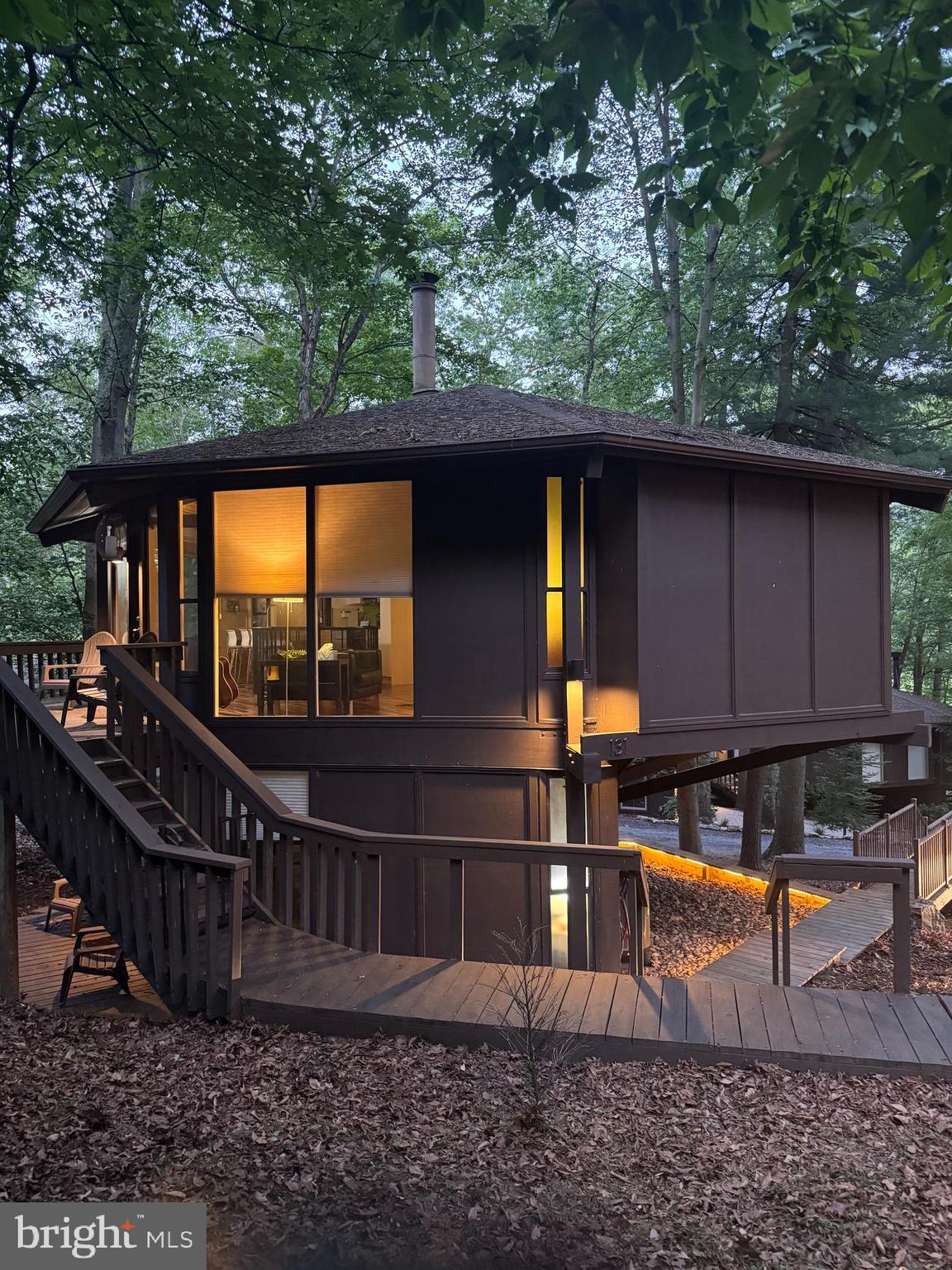 Everyone loves these Unique Homes, this one has you feeling like you are living in a treehouse. Sits nestled across from the Award Winning Omni Golf Course and Resort. Seller bought an extra .15 lot behind for added outside space . Walk in the door to lovely Brazilian hickory hardwood floors on the upper floor. Kitchen has been updated with white cabinets, stainless appliances and butcher block counters. Cozy living room space. Two bedrooms on this level, each with its own full bath. Head down the spiral staircase into a relaxing family room/game room area with cork flooring. Lower level also hosts a third bedroom with its own bath. Heat pump forced air electric heating and central air, step down a few steps inside to the washer/dryer and utility room space. This property is turn key- walk in ready , either for your own home, rental or ARBNB. Investors come take a look. This home was remodeled in 2020. Outside has a partial wraparound deck and lower deck area, with views of the mountains and trees. Call for your tour!