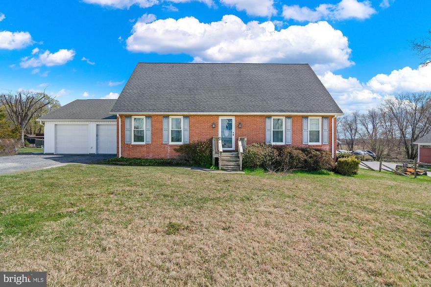 Enjoy the peace and quiet of a rural setting while still being just a short drive to Westminster or Reisterstown for shopping, restaurants, and everyday conveniences.  This well-maintained home features an attractive brick front with vinyl siding and a large yard that backs to trees, offering a nice sense of privacy. The fully fenced backyard provides plenty of space for outdoor activities and includes a storage shed. A rear deck connects conveniently to both the kitchen and the oversized two-car attached garage, which offers extra space for storage or a workshop area.  Garage also has double rear doors - ideal for tractor or ATV storage.  Inside, the kitchen has vinyl floors and the foyer, living room and dining room have hardwood floors.  Kitchen has a breakfast bar, and plenty of counter space, along with an electric range and over-the-range microwave. The washer and dryer are located just off the kitchen and there’s additional storage space in that area as well.  The main level includes two bedrooms and a full bathroom with a newer BathFitter shower stall and a linen closet. The primary bedroom has carpet and a ceiling fan, and the second bedroom also features carpet and a ceiling fan. The living room is spacious with hardwood floors, and the entry foyer also has hardwood flooring and a coat closet. Hardwood steps lead to the second floor.  Upstairs you’ll find two additional bedrooms and a full bathroom with a skylight, along with several closets and built-in storage cabinets.  Additional features include two-zone HVAC, 200-amp electrical service, central vacuum, and vinyl replacement windows that are approximately nine years old.  Lot size is .59 acres.