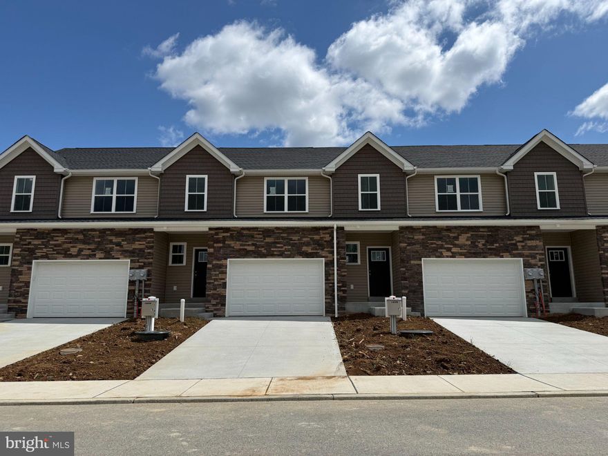 This gorgeous interior unit, modern craftsman-style home turns heads with its eye-catching stone facade, shake accents, and charming front door.  The heart of the home features a stunning, upgraded kitchen with white cabinets, quartz countertops, and a center island — perfectly connected to the dining and living spaces for easy entertaining or cozy nights in.  The open living spaces is a wide open, soaring great room with vaulted ceilings that instantly feels bright, airy, and welcoming.  Rear sliders lead to composite decks or concrete patios, depending on grade.  Upstairs, the spacious primary suite is your private retreat, complete with a primary bath with double bowl vanity and a walk-in closet big enough to impress. Two additional bedrooms, a full bath, and an oversized linen closet offer space for everyone.  These townhomes are designed with three professionally designed color palettes — so whether your style is bold, warm, or cool and modern, there’s an Addison that fits your vibe. Plus, this is truly low-maintenance living — the HOA takes care of lawn care and snow removal. Pair that with an oversized one-car garage and a location in charming Fleetwood, and you’ve got the ultimate in carefree, luxury townhome living.  One more thing...backed by the one-year Builder Warranty, we've got you covered!