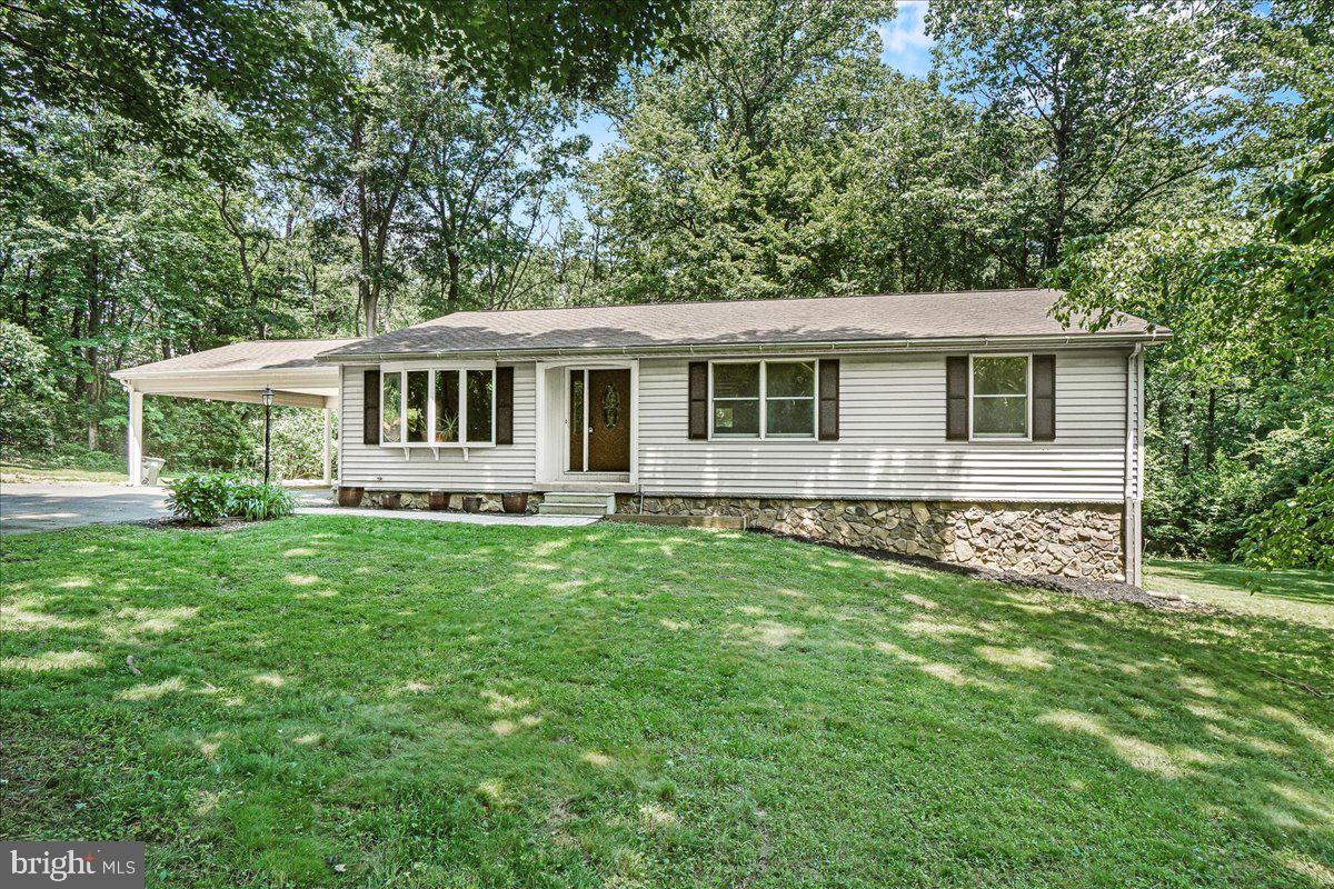 Discover your perfect escape in this cozy home nestled on approx. 3.79 acres of serene, forested land that backs directly to Carroll Creek, offering exceptional privacy without sacrificing convenience. Located just minutes from town, highways, and all that Frederick has to offer, this property combines peaceful country living with easy access to everyday amenities. This home boasts a large, open kitchen with granite countertops and ceramic tile flooring. Enjoy elegant dinners in the formal dining room, brightened by a charming bay window and rich hardwood floors. Relax and entertain in the spacious living room that opens onto an elevated deck overlooking stunning natural views and mature trees - perfect for enjoying quiet mornings or lively gatherings around the fire pit. The primary suite includes two closets and a private bath for your comfort. The partially finished walkout lower level provides additional living space and a great opportunity to add a ton of additional finished square footage or storage space. This property combines peace and privacy with accessibility. Don’t miss this exceptional opportunity to make this home your own!