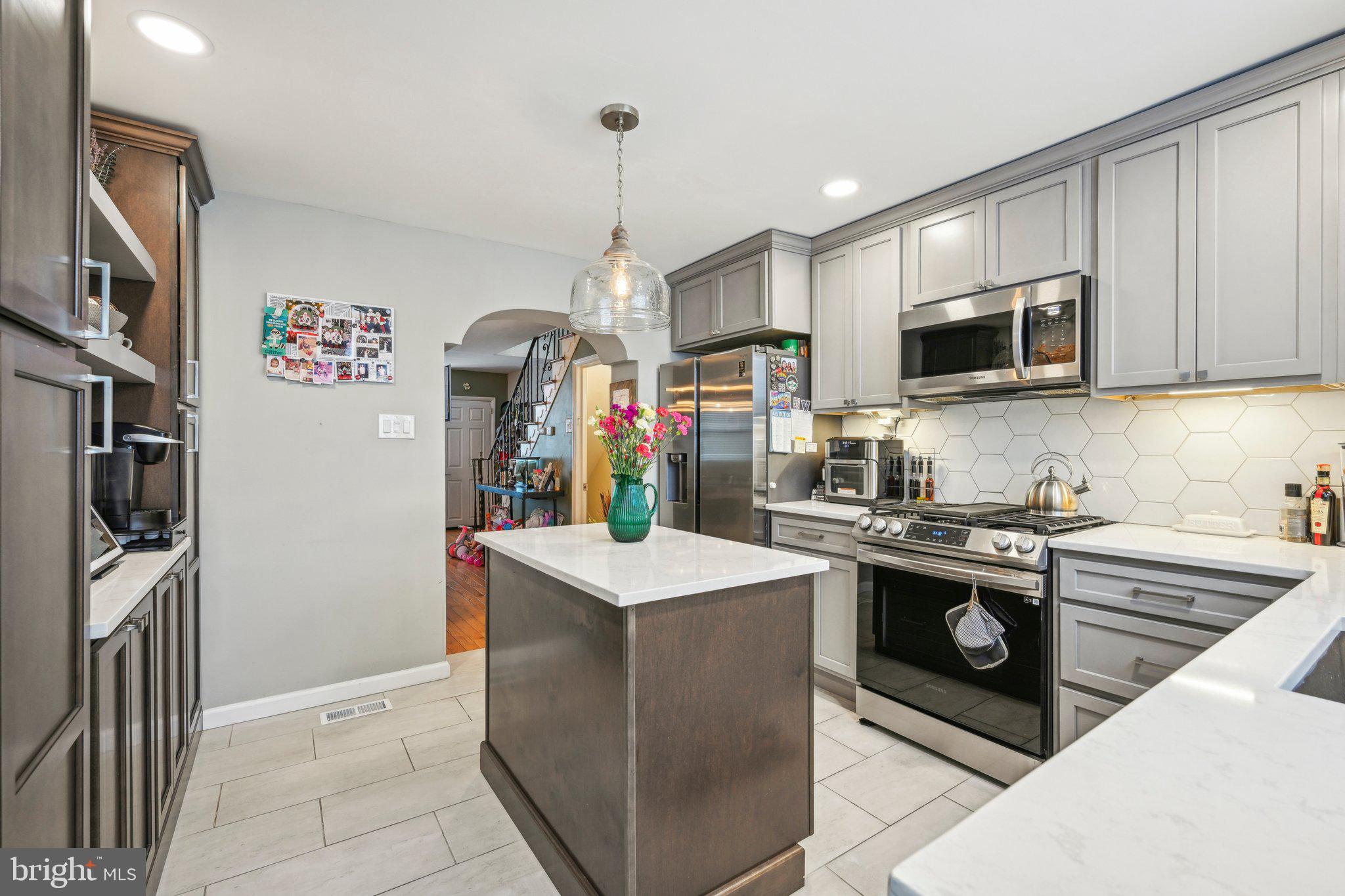 Welcome to 537 Wilder Street, a charming South Philadelphia rowhome that blends original character with modern updates. Step through the preserved vestibule into a spacious first floor featuring open living and dining areas, an updated kitchen with contemporary finishes, and access to a private rear outdoor space—perfect for relaxing or entertaining. Upstairs, you’ll find three bedrooms and a fully renovated center hall bathroom with a stylish tiled tub surround. The middle bedroom is smaller but ideal for a home office, nursery, or a dream walk-in closet. The partially finished basement offers a flexible space to hang out and watch a game, work from home, or work out, complete with a convenient powder room, while the rear of the basement houses the mechanicals and laundry area. Located within walking distance to Herman's Coffee, Dickinson Square Park and Passyunk Avenue’s top restaurants and shops, and just minutes from Bok, Center City, this home offers the perfect mix of comfort, convenience, and neighborhood charm.
