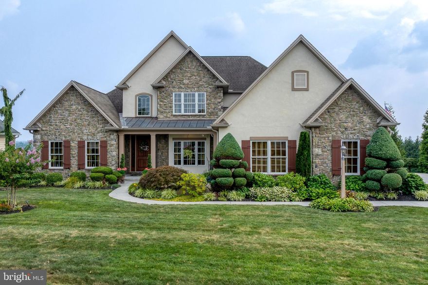 Uncompromising Elegance inside and out! Exquisite Hampden Summit Estate | 4 Bed | 3.5 Bath | 3-Car Garage | Panoramic Views and does not disappoint!

Step into unparalleled luxury in this stunning Hampden Summit residence, custom-built by Carlson Construction, where exceptional craftsmanship meets elevated living.

From the moment you arrive, you’ll be captivated by the expansive 3-car garage, professionally landscaped grounds, and a tranquil front koi pond. Enter through a grand 48" front door into a welcoming foyer that sets the tone for the home’s elegance.

To the left, a formal living room or office features French doors for privacy. To the right, a beautifully appointed dining room stuns with a stone archway and built-in buffet—ideal for entertaining.

The heart of the home is the two-story family room, showcasing expansive windows, an elegant two-sided stone fireplace, and 18-foot ceilings that flood the space with natural light. All windows feature custom Hunter Douglas wood blinds, including remote-controlled blinds in the family room.

The chef’s kitchen is a dream:

ALL Viking appliances 

Custom cabinetry

Tiered island with pendant lighting with stunning granite and beautiful matching sinks.

Sunny breakfast nook overlooking breathtaking scenery

The first-floor Owner’s Suite is a private retreat with a tray ceiling, spa-inspired bathroom, and a California Closets-designed walk-in closet.

Upstairs, you’ll find three spacious bedrooms, including two currently furnished with king-size beds—perfect for guests or family.

The walkout Lower Level is a true extension of the home—not a basement—with 9-foot ceilings, high-end finishes, a full bath, and direct access to a hot tub oasis.

Outdoor Living at Its Finest:

Elevated Trex deck with panoramic views of Bayshore Farm and all the way to Ski Roundtop

Two sitting areas plus a fully equipped outdoor kitchen

Additional private entertaining areas along the side and rear of the home

Additional Features:

Open-concept layout ideal for modern living

High-end finishes and fixtures throughout

Rich walnut hardwood flooring

Located in Hampden Township, within Cumberland Valley School District

This is a rare opportunity to own one of the most exceptional homes in Hampden Summit—where every detail is thoughtfully designed, and the views are simply unforgettable.