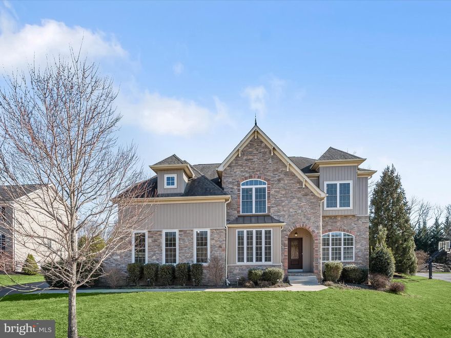 Exquisite French Country/Chateau-Style Home with Elegant Rustic Charm!

Formerly a Viking model home, this stunning residence is loaded with builder upgrades and premium finishes. The steeply pitched stone façade and extended stone privacy wall set the tone for timeless elegance. Inside, engineered wood floors and solid core doors with beadboarded texture and bronze hardware add warmth and sophistication.
Designed for modern living, the open-plan layout seamlessly connects the spacious family room with a gas fireplace,  and adjacent gourmet kitchen with gas cooking, two islands, pantry and beverage cooler.  Living and dining formals are complemented by arched windows, crown molding and panel wainscoting,    A sunroom off the kitchen brings in natural light, while a private study offers a quiet retreat and work at home space. Thoughtful conveniences include a secondary side entry and built-in cubbies in the mudroom, a finished lower level with a recreation room, game area, full bath, ample storage, and double walk-up stair access.
Upstairs, the primary suite is a luxurious escape, boasting a tray ceiling, oversized walk-in closets, and a spa-like bath with dual vanities and soaking tub. Three additional bedrooms include a private ensuite and two bedrooms that share a hall bath.
Outdoor living is exceptional with expansive front and rear lawns, a stone privacy wall, basketball hoop, low-maintenance deck with awning, paver dining patio, circular paver fire pit patio, stone garden wall, hot tub, and a dual-entry storage shed.
Come home to a one-of-a-kind opportunity with premium craftsmanship and exceptional amenities. Don't miss this masterpiece  with builder enhancements and upgrades at every turn!