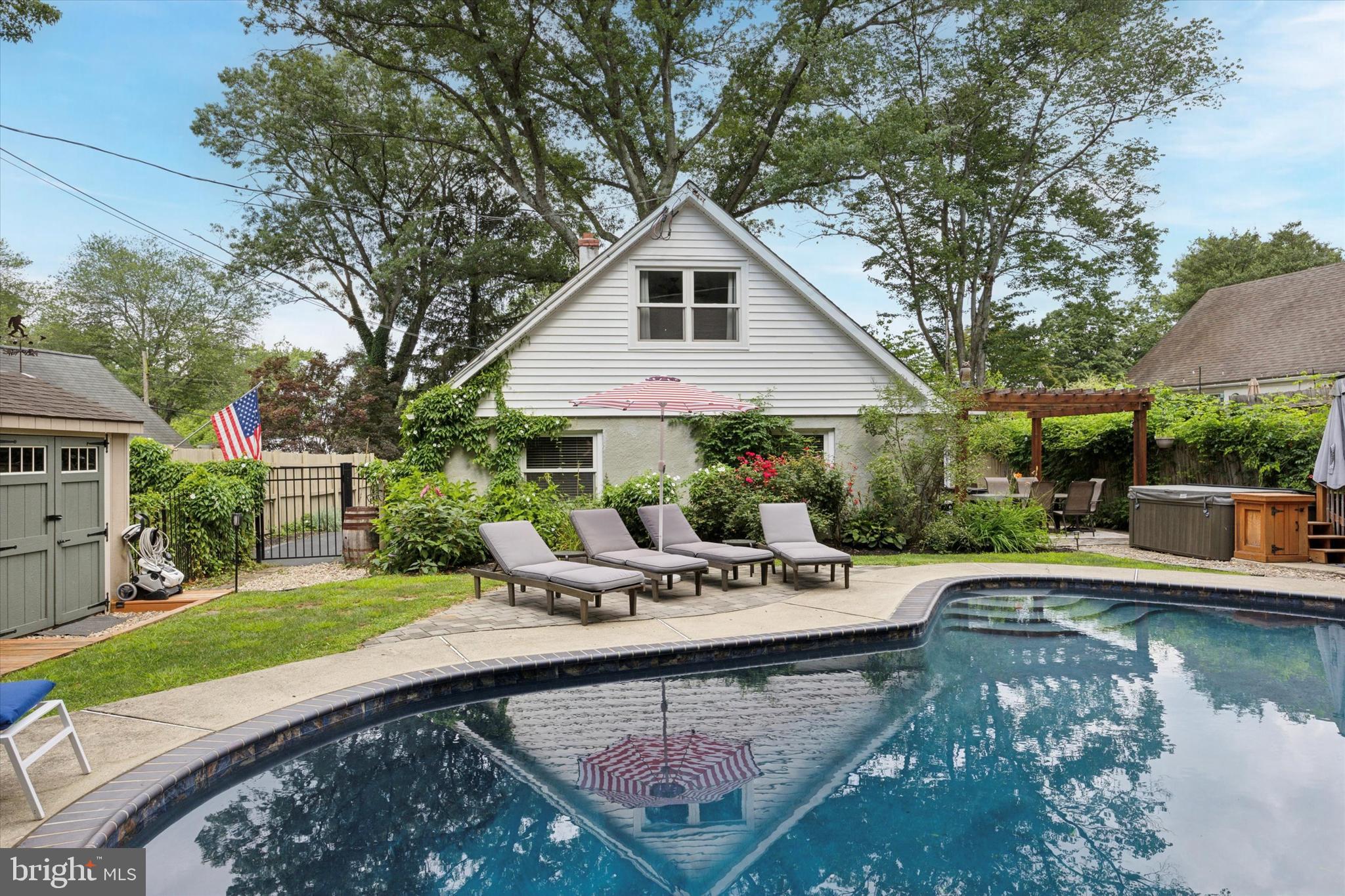 Effortless style, thoughtful updates, and a dream location — 705 Hillside Drive delivers it all.
Tucked on a quiet street just a short stroll to the heart of West Chester Borough, this beautifully updated Cape Cod is where timeless charm meets modern convenience. With inviting indoor-outdoor spaces and well-thought out extras throughout, this home is the perfect blend of vibrant community living, peaceful privacy, and easy access to all the perks of borough living. From the well-manicured lawn to the covered front porch with a classic porch swing, the curb appeal of this home can’t help but to draw you in. Step inside to a bright and open main level elevated by character-rich finishes and natural light.To the right, the eat-in kitchen is every chef’s dream and a true showpiece — complete with granite countertops, stainless steel appliances, a double oven, pot-filler, and a farmhouse sink. A wine and beverage fridge, pantry, and oversized island with seating make this kitchen as functional as it is beautiful. It opens directly into a spacious family room with a shiplap accent wall and continues into the multi-use dining area with glass sliding doors to your own backyard oasis. The 1st floor bedroom makes one level living a possibility, whether you are looking for yourself or for an in-law suite. Also featured on this main level is a spa-like full bath featuring a rain shower, clawfoot soaking tub, and a stylish farmhouse sink. A hallway coat closet and additional storage round out the main floor. Head to the second level where you will find two more generously sized bedrooms, a bonus room perfect for a home office, playroom, walk-in closet, and barn door access to the laundry area. The backyard is where this home truly sets itself apart. Step through the glass sliders to a private, fully fenced oasis with a pergola-shaded patio, in-ground pool, hot tub, an additional paver patio, and two fully finished sheds with vaulted ceilings, electricity, and AC offer an extra 200 sq ft of flexible living — perfect for a home office, studio, gym, or guest overflow. A third custom utility shed with a loft and outdoor workbench adds function without sacrificing form. Just a few blocks to Marshall Square Park and minutes to everything downtown West Chester offers — renowned dining, breweries, boutiques, year-round festivals, Henderson High School, Chester County Hospital, and West Chester University — this location can’t be beat. Major upgrades include a new roof (2018), hot water heater (2020), and other recent updates adding peace of mind to this already turnkey home. Low taxes, thoughtful upgrades, and incredible versatility make this property a true standout. 705 Hillside Drive is more than a home — it's a lifestyle.