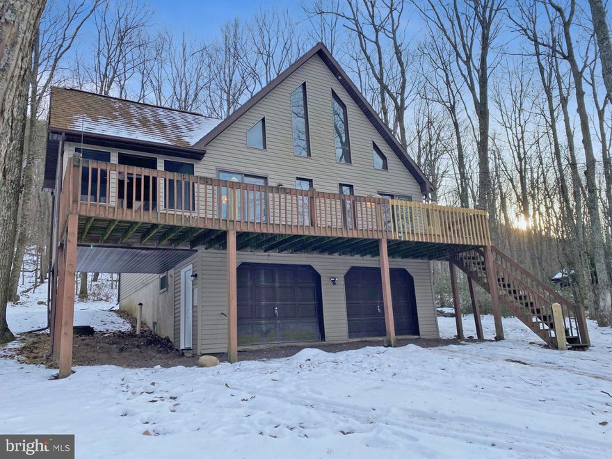 Set in the gated community of Beech Mountain Lakes, this home is situated on a wonderful lot with no homes behind it, providing added privacy. As you enter through the patio door, you'll find a welcoming living room/dining room with a stone fireplace and full front wall of windows, skylights & freshly painted walls. The kitchen area features new flooring, fresh paint, and brand-new stainless-steel appliances included with the home. The main bathroom has updated flooring, fresh paint and a new toilet. The first-floor bedrooms offer new carpet, paint, and ceiling fan. Upstairs, you'll find a cozy loft area with new carpet and paint, leading into the master bedroom and master bath area. The master bedroom also has a balcony where you can enjoy your morning coffee while taking in the beauty of nature. The master bedroom and bathroom area also features new flooring, fresh paint, along with a new toilet. The lower level is finished, providing a great family room space with a half bath and laundry area. There is plenty of parking available in the built in 2 car garage or in the gravel driveway. This home is offered at $239,900.