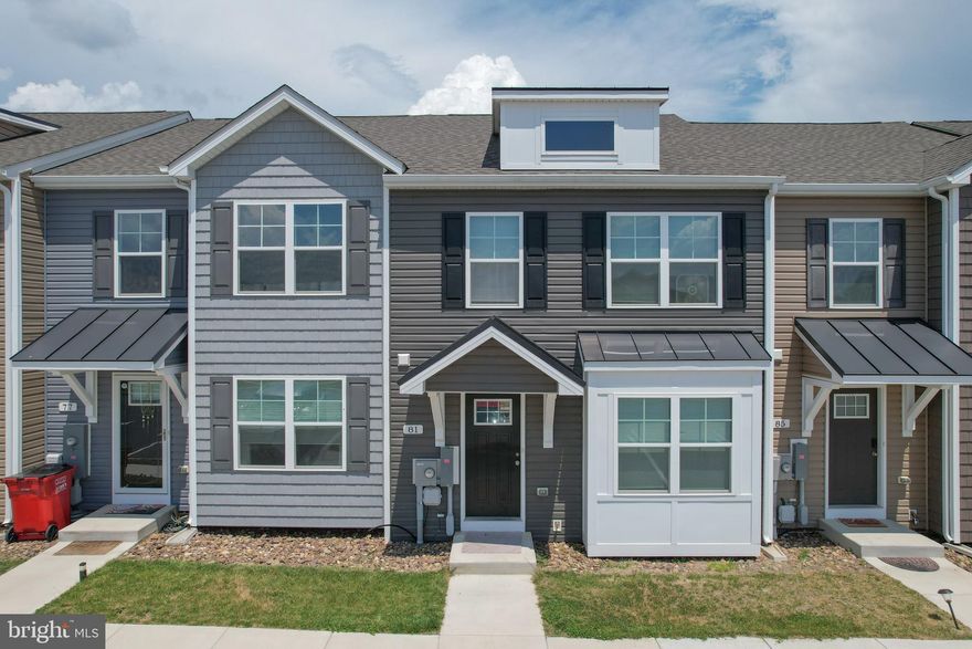 Welcome home to this beautifully designed 3-bedroom, 2.5-bath 2-story townhome offering modern finishes and spacious living throughout. The main level features luxury vinyl plank flooring, generous room sizes, and a bright, open layout with a bumped-out family room for additional living space. The kitchen is equipped with a center island, granite countertops, pantry, and plenty of cabinet space, making it perfect for both everyday living and entertaining.  Upstairs, the spacious primary suite includes a walk-in closet and private bath with double vanity and a tiled shower featuring a glass door. Two additional bedrooms and a full bath provide comfortable accommodations for family or guests.  Additional highlights include natural gas heating, attractive brick accents on the front exterior, and a 10x12 rear deck ideal for relaxing or outdoor gatherings. Conveniently designed with both style and functionality in mind, this townhome is ready to welcome you home. Moving to WV? Look no further than this affordable townhouse tucked away in Martinsburg, WV! Book your showing today!