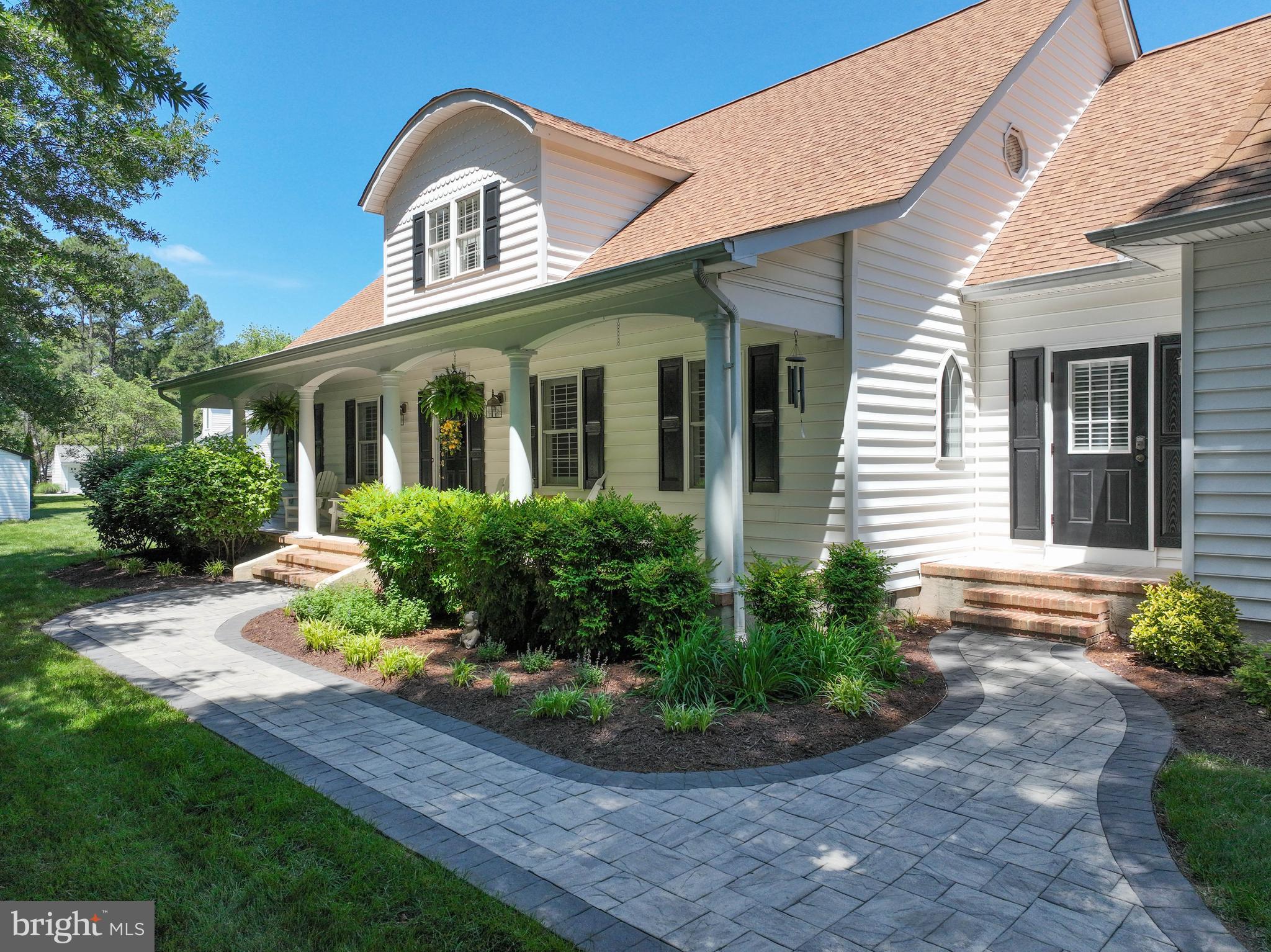 This beautifully maintained Cape Cod offers the perfect blend of charm, space, and functionality, tucked away on a quiet cul-de-sac with peaceful pond views. With 4 bedrooms, 3.5 baths, and a flexible open layout, this home is designed for both comfortable everyday living and effortless entertaining. A paver walkway leads to the inviting front porch, setting the tone for what’s inside. Step through the front door and immediately enjoy views of the pond, visible through the home's large, light-filled windows. The open floor plan makes it easy to host everything from casual crab feasts to festive holiday gatherings. The family room featuring an impressive stone fireplace flows into the dining area and large well-appointed kitchen with granite countertops, a large island, and newer stainless steel appliances. Just off the kitchen, a spacious animal proofed screened porch with custom stamped concrete floors provides the perfect spot to relax, dine, or simply take in the view. The first-floor primary suite offers private access to a second screened porch—ideal for enjoying your morning coffee. The en-suite bath includes dual vanities, a soaking tub, and a stand alone shower. There is also a generously sized walk-in closet with custom shelving. Also on the main level is a laundry/mudroom with outdoor access. There is a den on the main level, perfect for a home office/study/library or another sitting area. Upstairs, you'll find three generously sized bedrooms, a spacious full hall bath with a soaking tub and a separate walk-in shower. The upstairs of the home also boasts ample storage and closet space, including walk-in bedroom closets as well as storage in the attic eaves. The oversized two-car garage features generous shelving, upgraded lighting and heaters. There is a separate generator plug and separate panel. Above the garage is a large bonus room, bathroom and storage closet which can serve as a 5th bedroom, second living area, theater room, or another office—offering the flexibility to meet your needs. The backyard is designed for enjoyment, with a large trex-type decking, a paver patio and built-in fire pit with custom seating area. Spend your afternoons fishing in the pond, lounging in the hammock, or entertaining friends outdoors. This peaceful property is professionally landscaped and well cared for. Throughout the home, you’ll find many well thought out charming features including wide-plank pine flooring, plantation shutters, pocket doors, curved archways, French doors, transom windows, and natural light streaming in from every angle—adding to the warmth and character of this special property. Please note that the house square feet on the SDAT records is incorrect and does not include the bonus room above the garage. The total actual square feet is 3694 and you will enjoy every inch of the space as you vacation where you live. Welcome home!